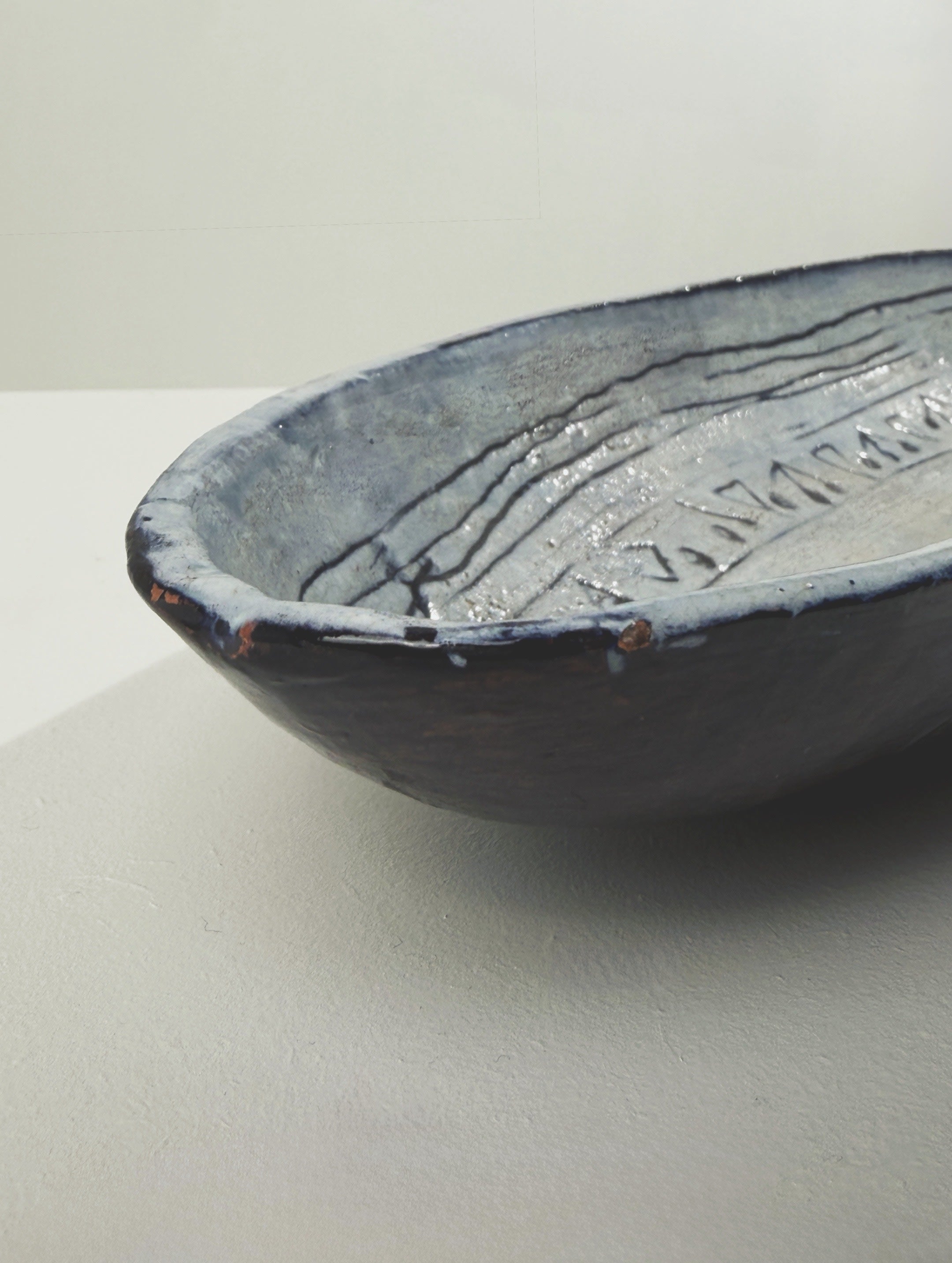 Large Oval Ceramic Dish, France, 1964. — angled view highlighting textured blue glaze