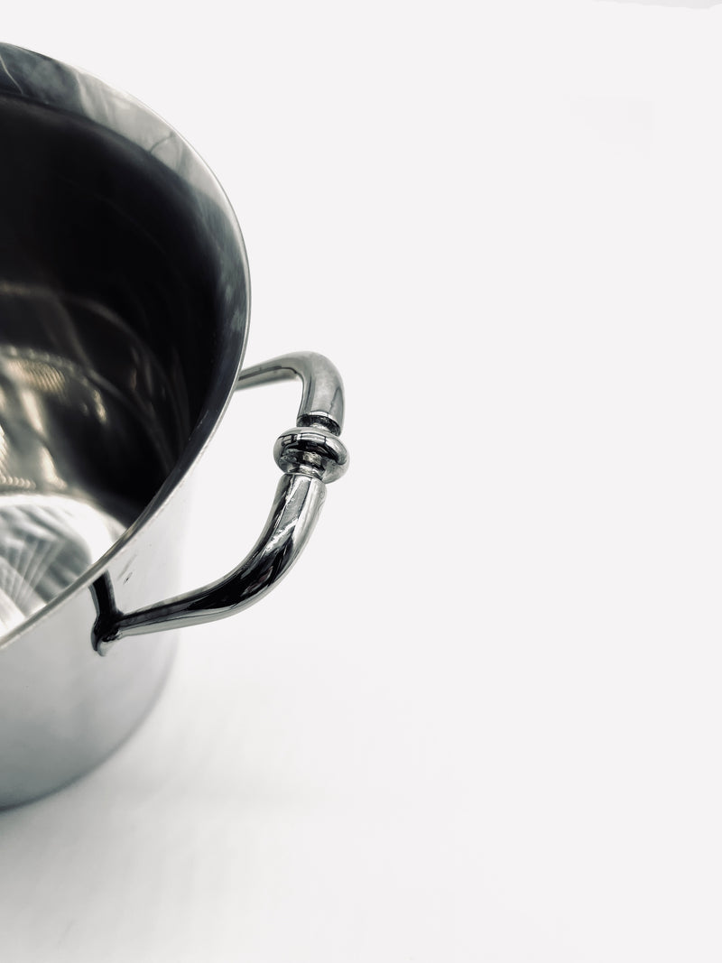 Close-up detail of curved steel handle on vintage champagne cooler