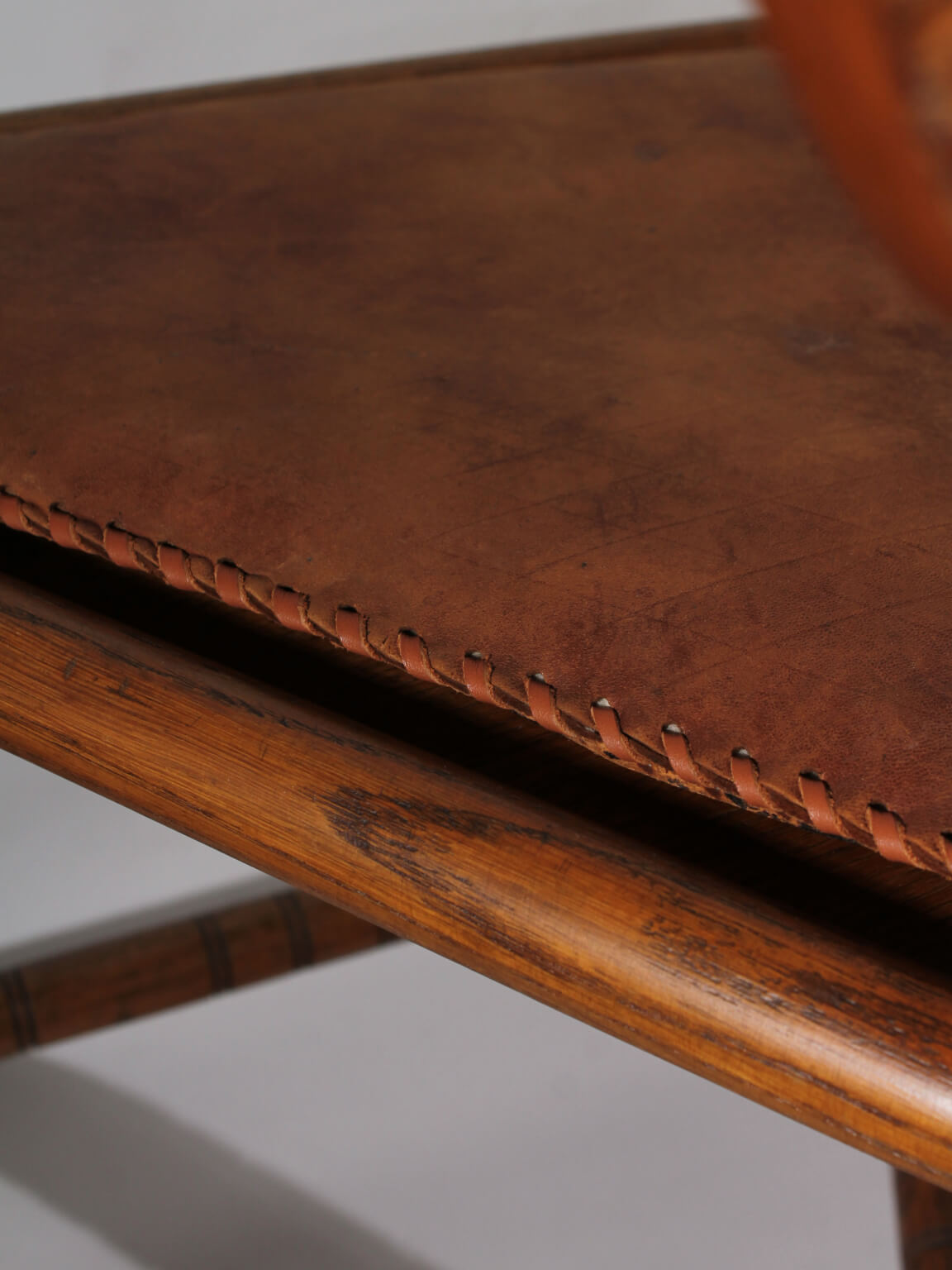 Swedish Carved Oak Monk Chair — close-up of leather seat stitching