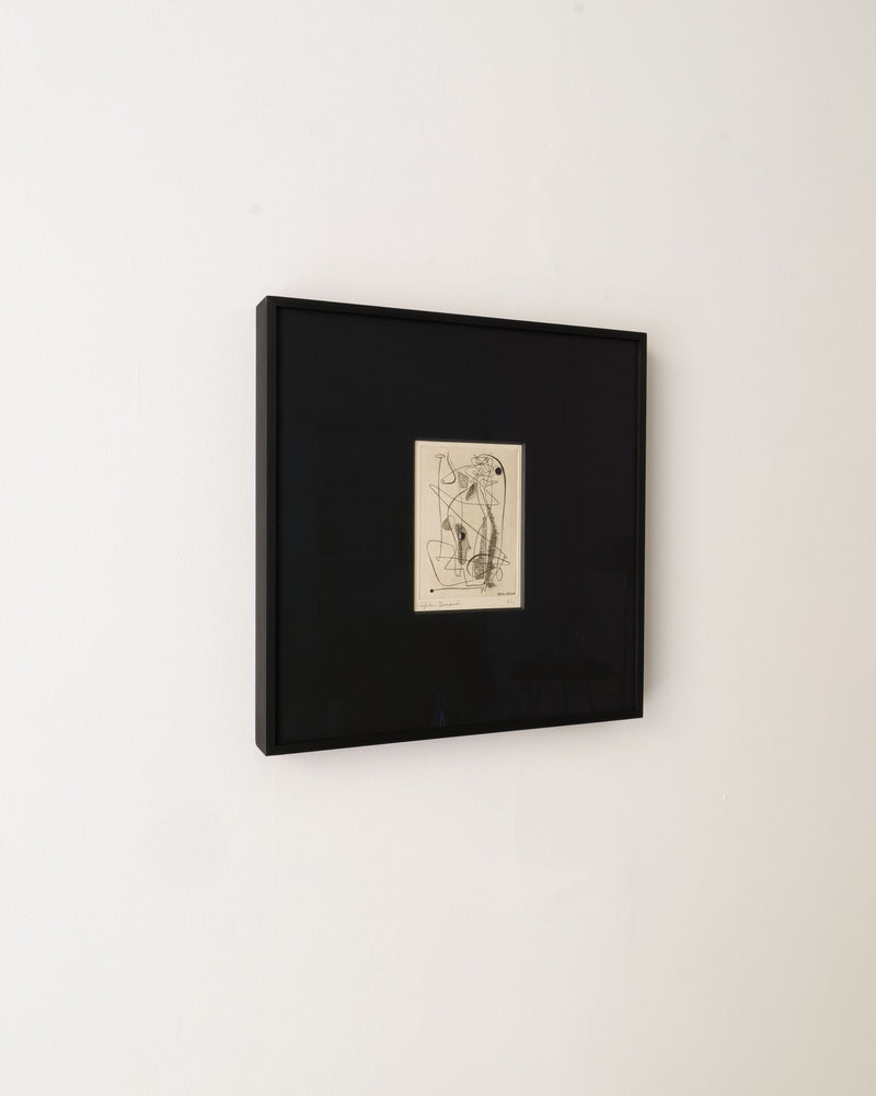 A signed Surrealist Engraving by Sylvain Durand from Collection apart, featuring minimalistic overlapping lines in a black frame, centers on a plain white wall as an abstract figure.