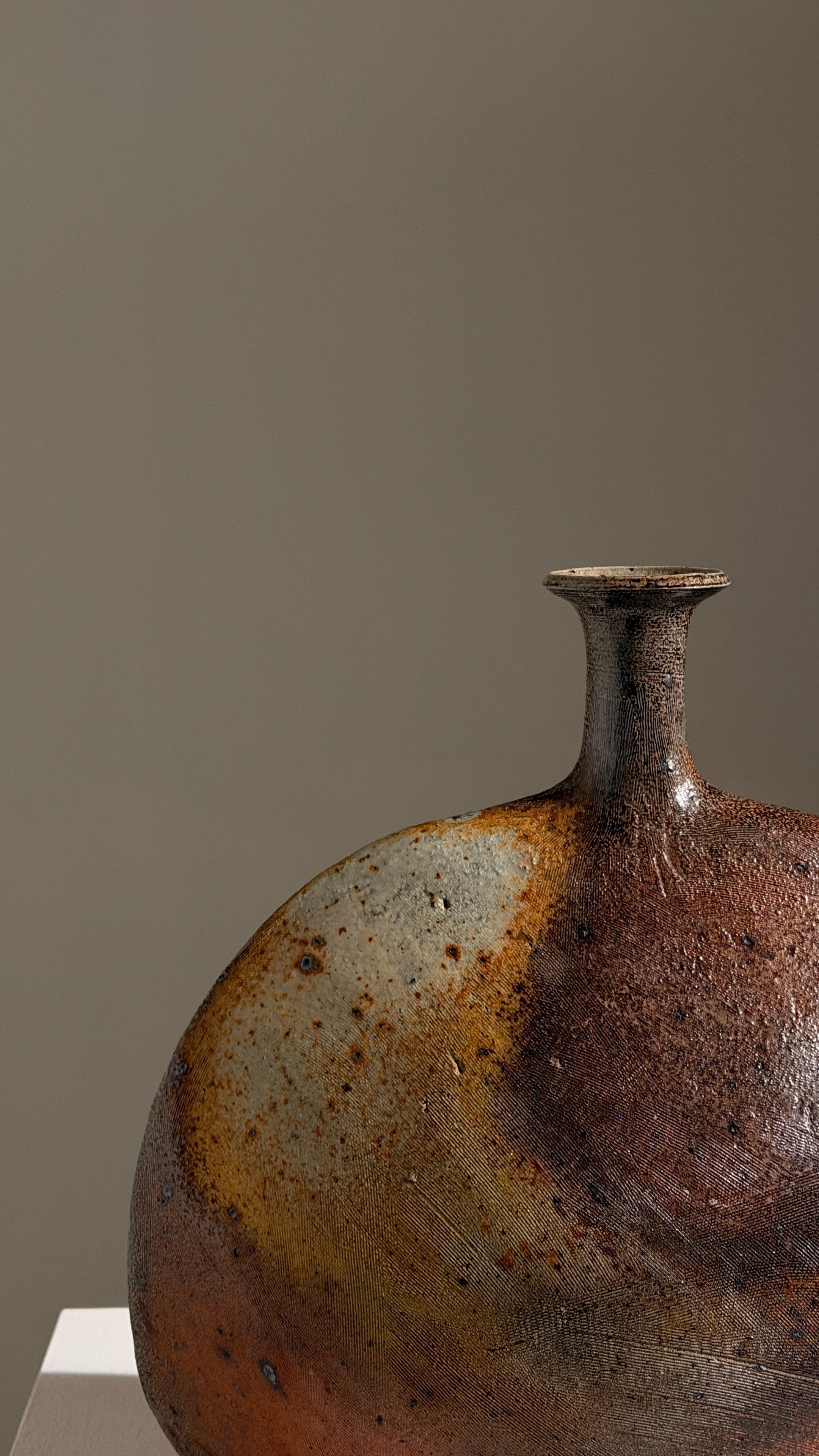 Large bottle vase by Gustave Tiffoche — side angle showing ceramic texture