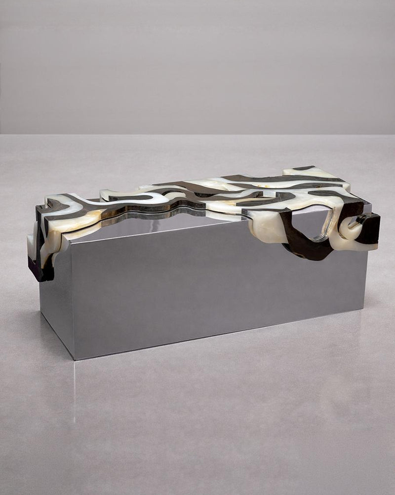 Orbis Bench II — close-up of polished metal surface with organic design