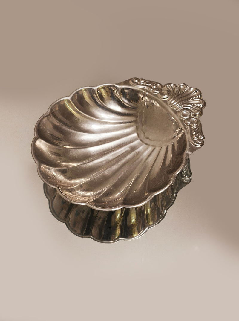 Large steel shell-shaped decorative dish with ornate baroque handle