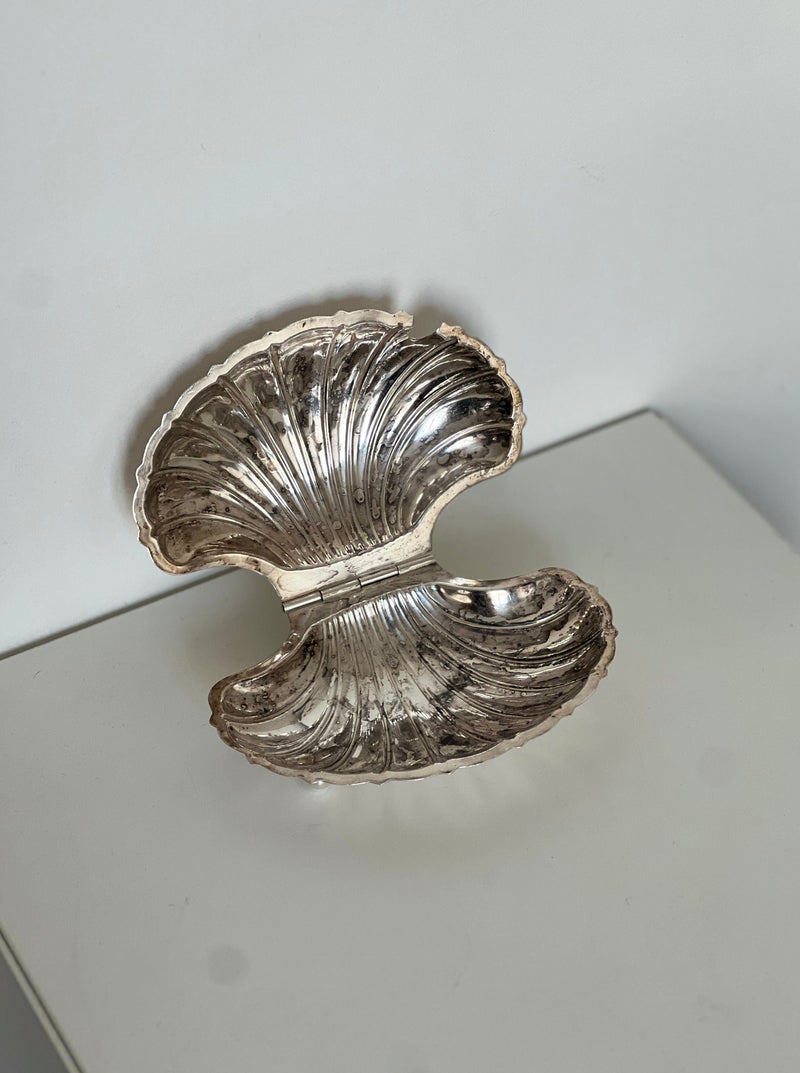 Silver shell-shaped decorative dish with ribbed texture detail