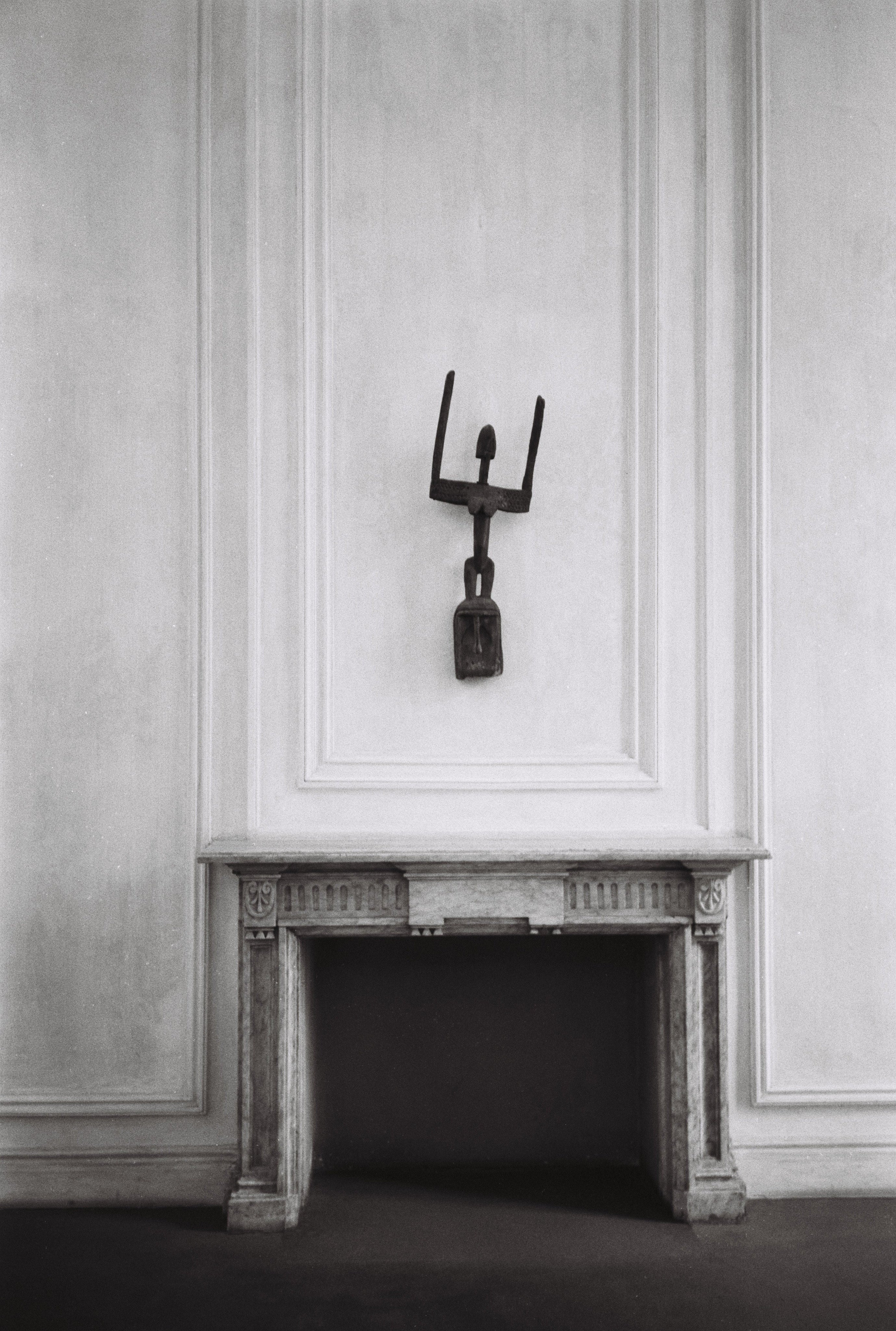 A minimalist room with a white ornate fireplace and sculptural wall art is the ideal backdrop to showcase COSEINCORSO's Memory #03 — Contemporary Photography in an aluminium frame.