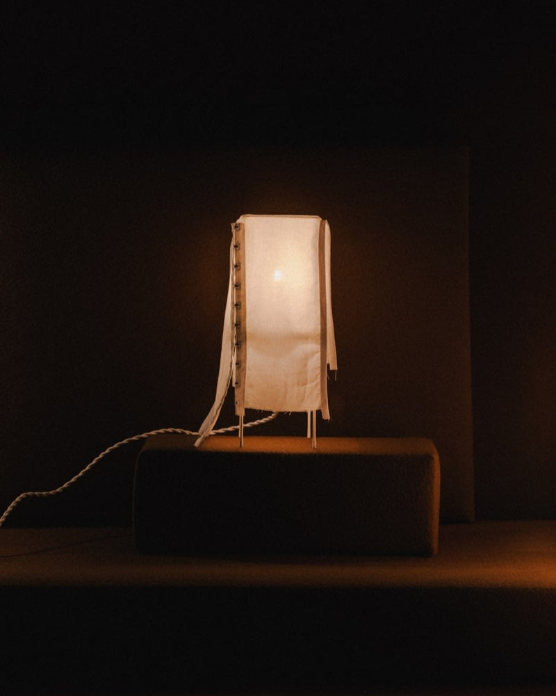Experimento 1.4 table lamp with translucent shade on wooden surface