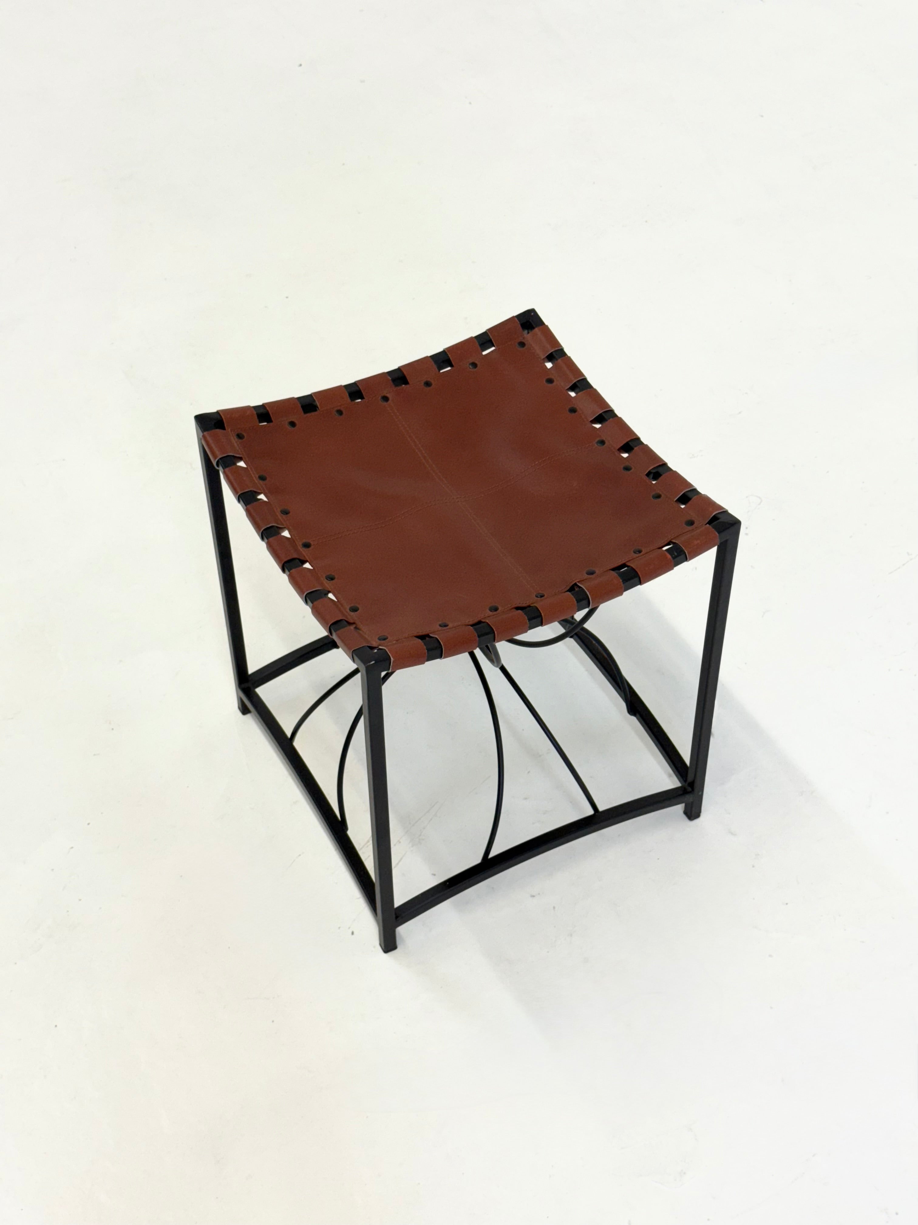 Elegant vintage French stool with black metal and brown leather — close-up