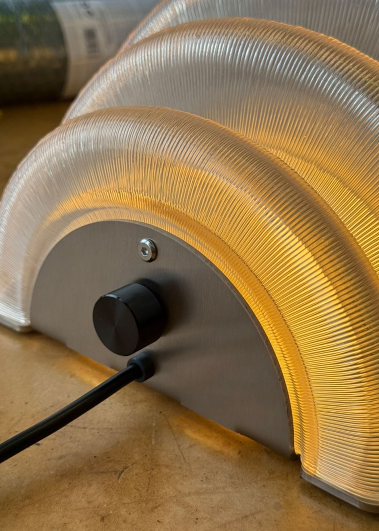 Curved ribbed glass shade detail of Hive wall light with cord