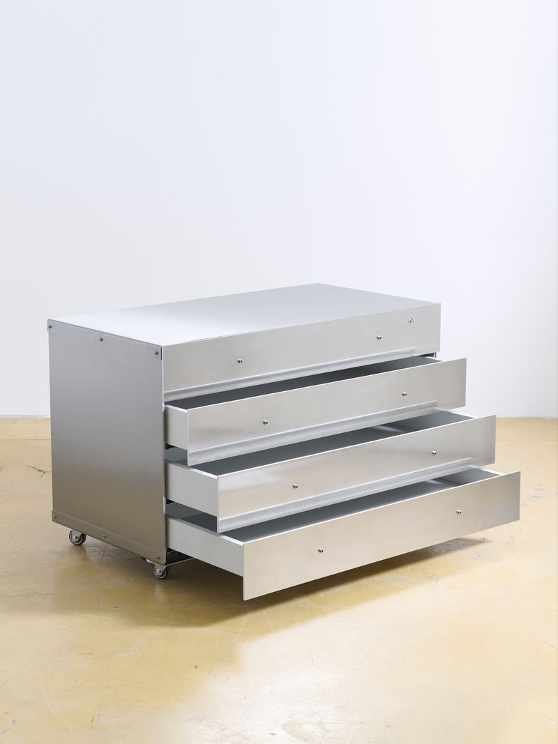 Chest of Drawers — close-up of silver metal surface with open drawers