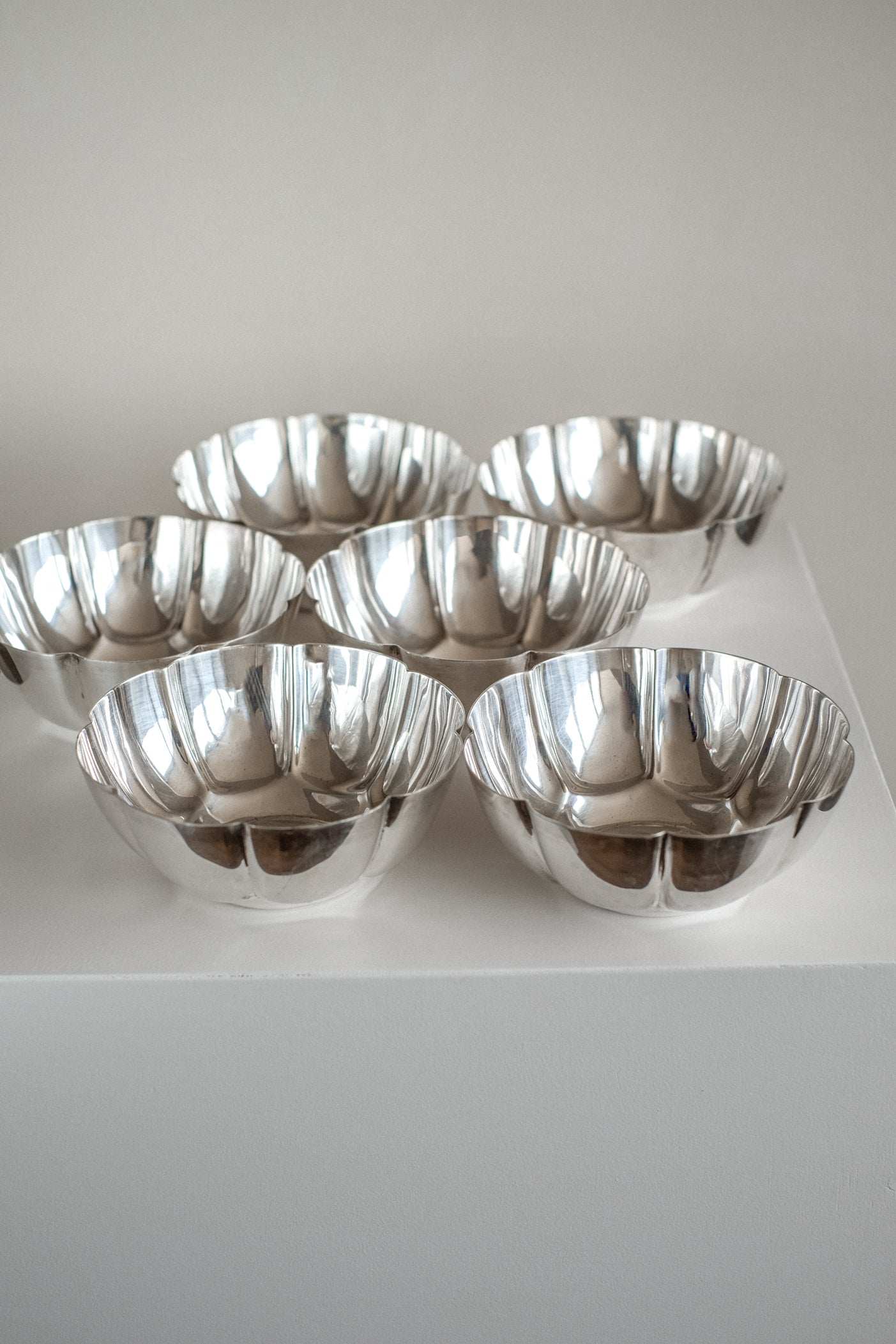 Set of 6 Silver-Plated Bowls 1960s — side angle showing reflective surfaces on display