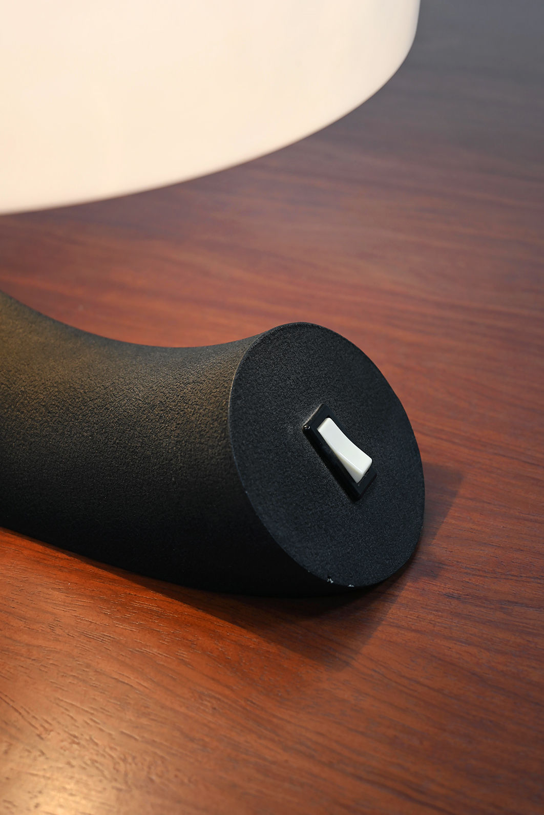 Detail view of Concordia table lamp base with USB port on wood surface