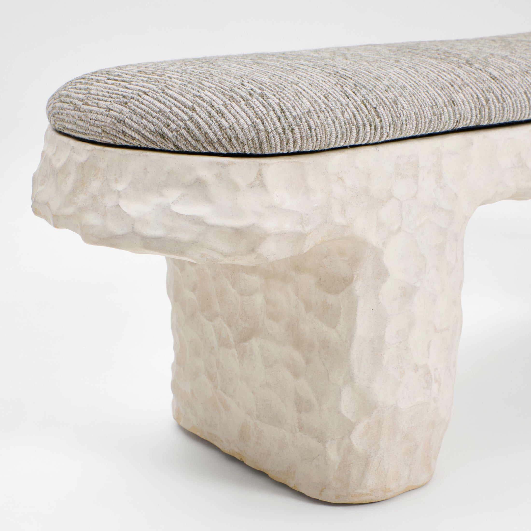 Perícia Ceramic Bench — close-up of textured ceramic base and fabric seat