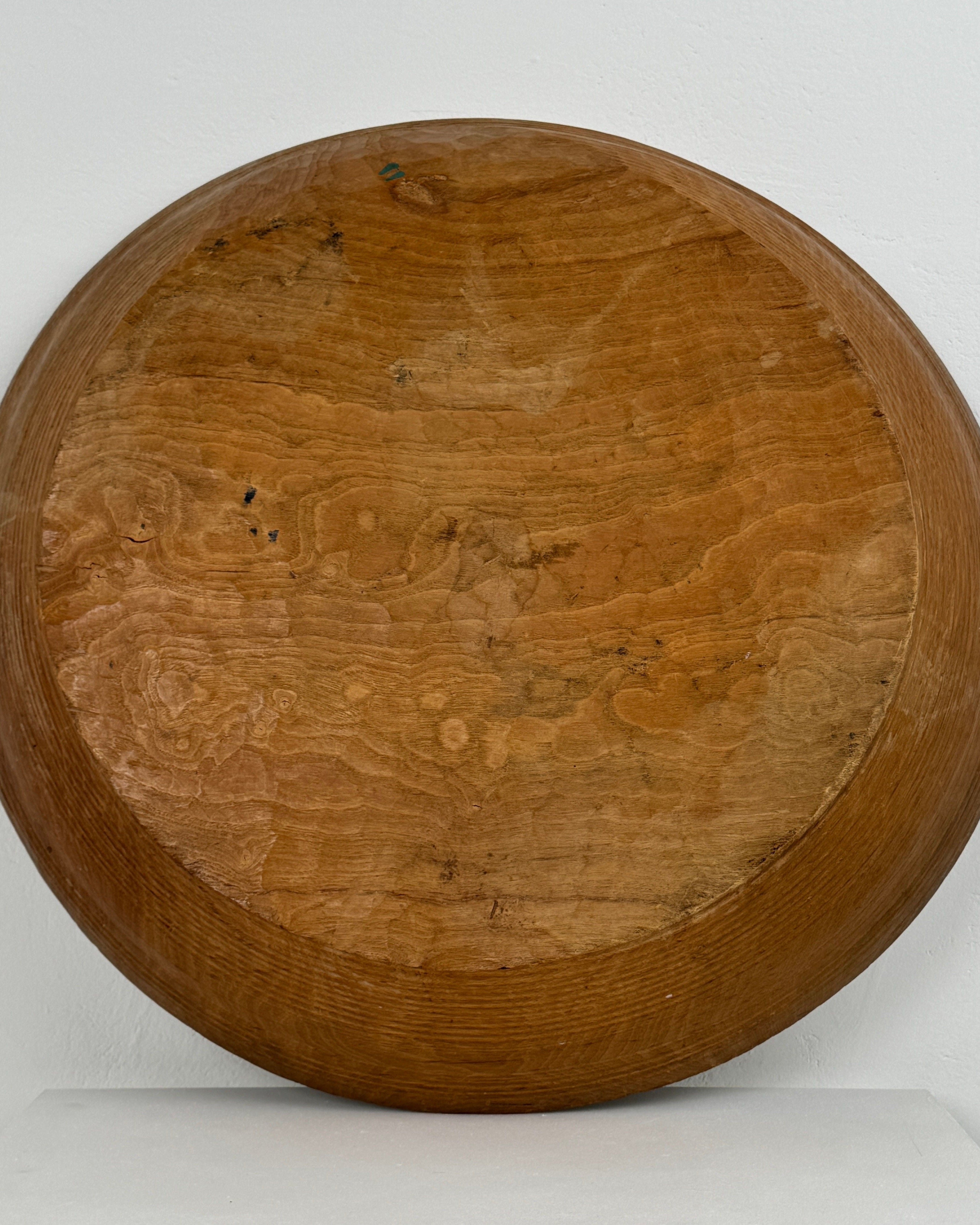 Bottom view of XXL carved wood bowl showing natural grain patterns
