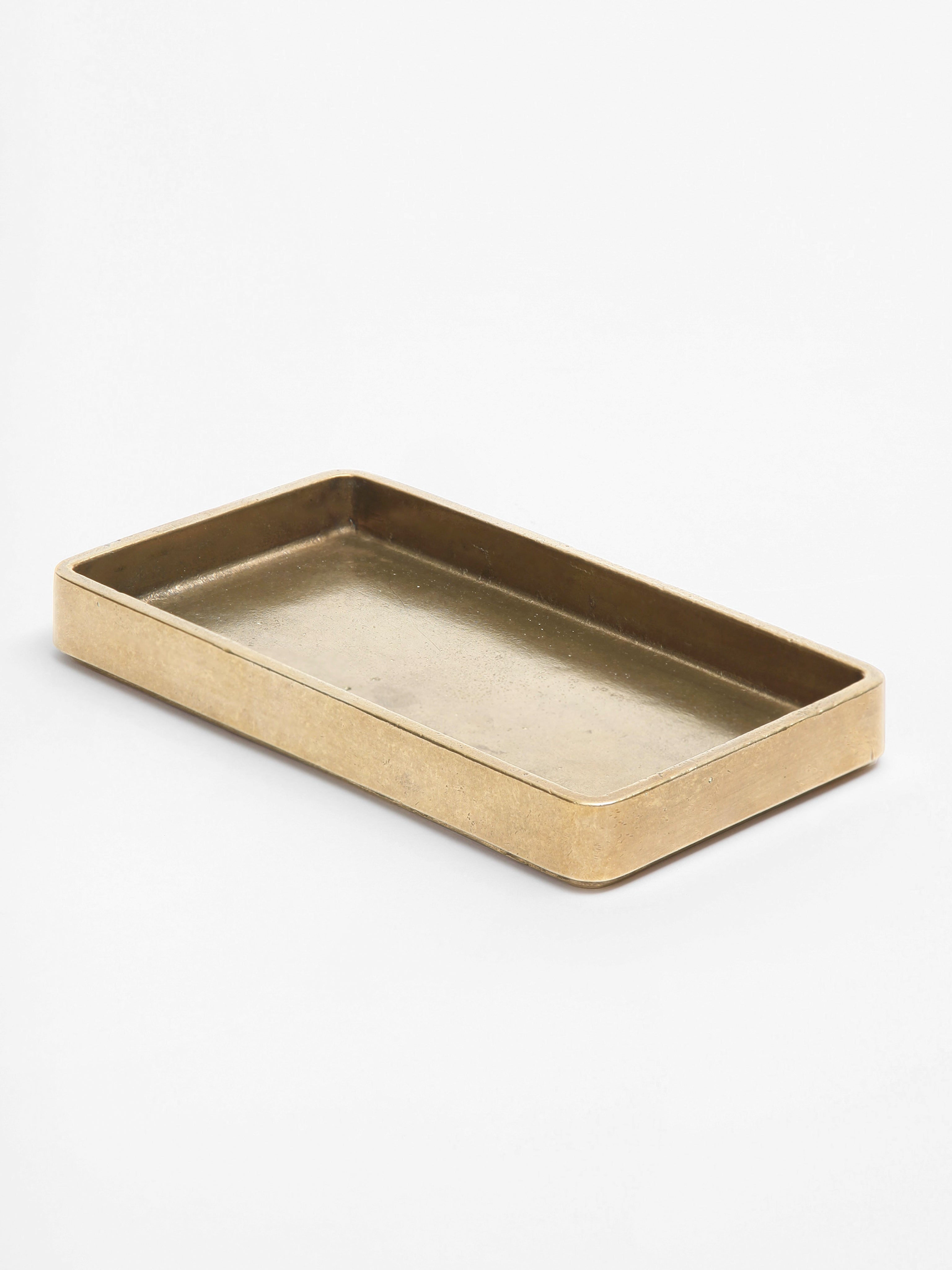 Plato Table Tray — side angle of brass surface on white background