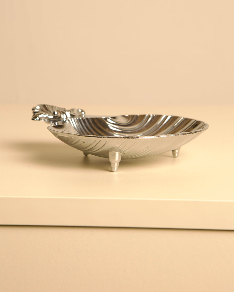 Silver-plated shell dish with decorative handle and three legs