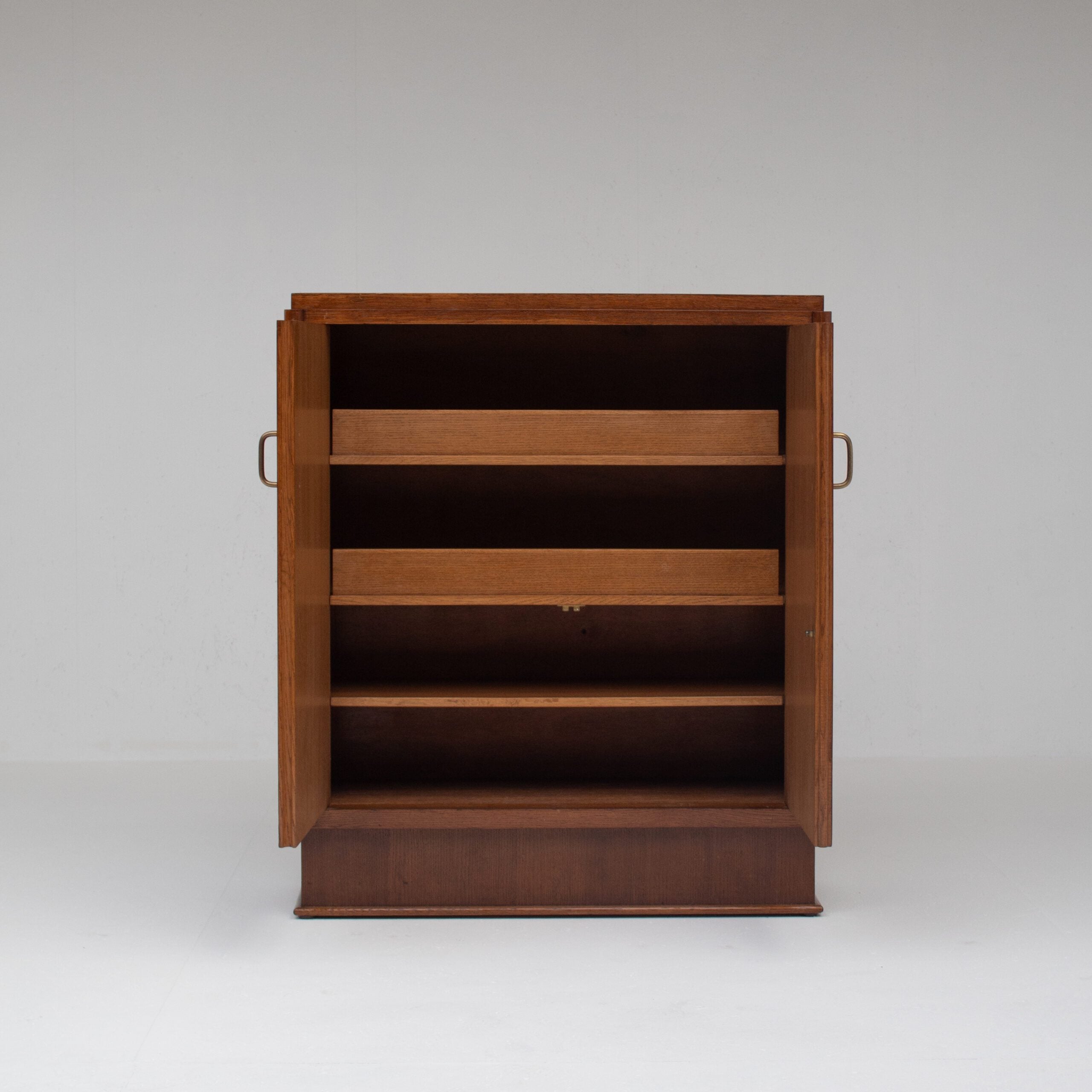 Mid-Century Oak Cabinet with Brass Handles and Decorative Inlays — detail view