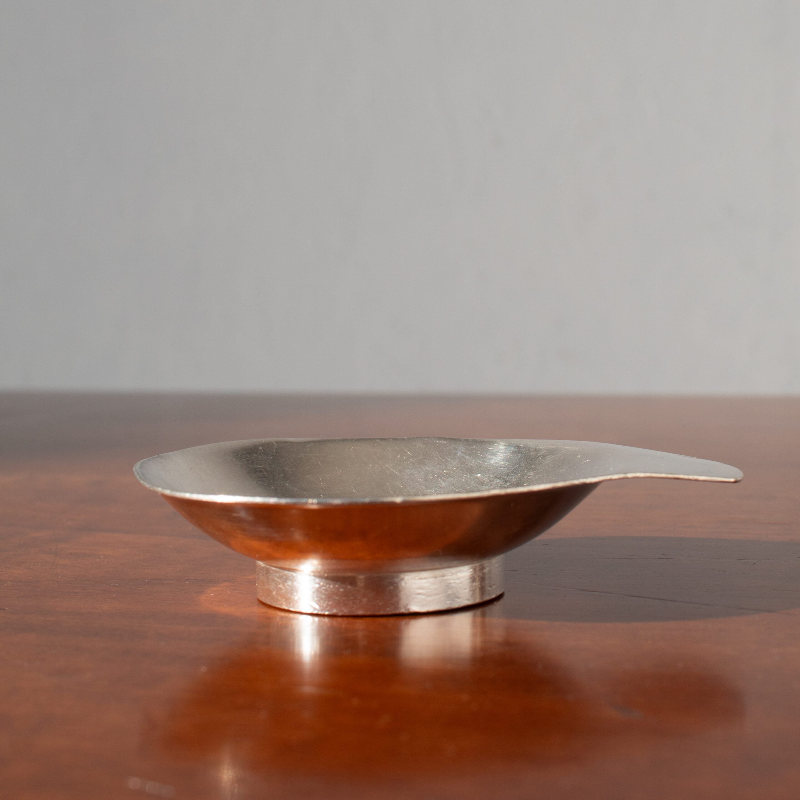 Arthur Krupp Dessert Plates in Metal — back view showing smooth metallic finish