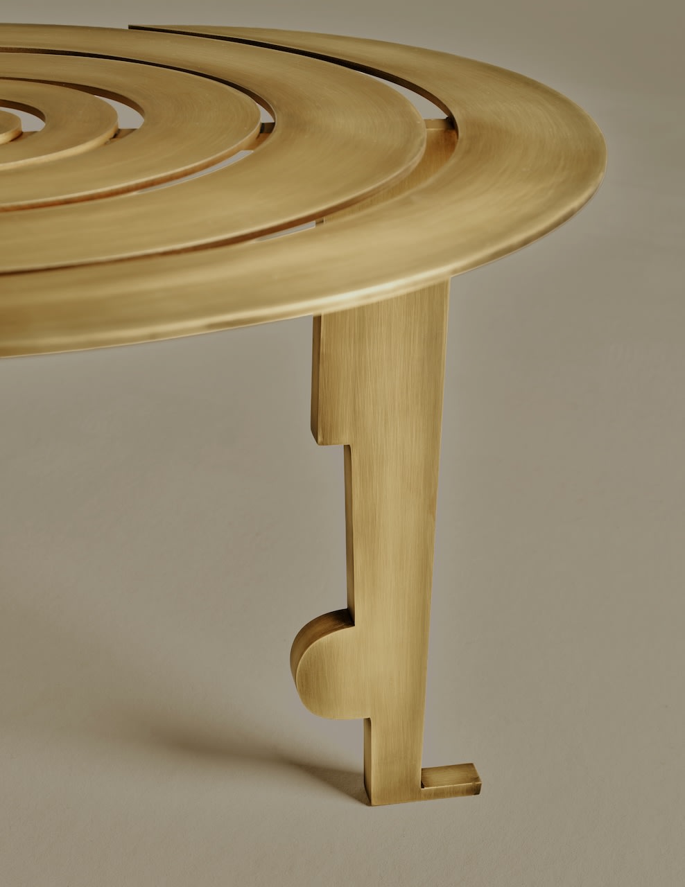 Colette Table — angled view of brass surface and leg detail