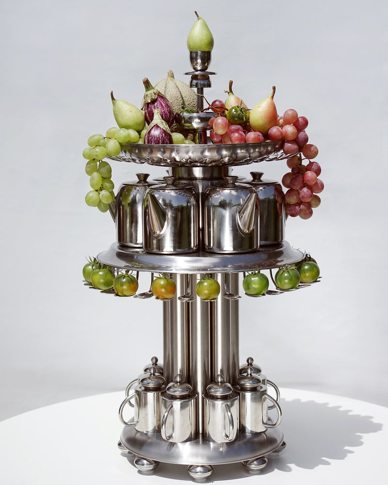 Tiered stainless steel tea service stand with fruit display