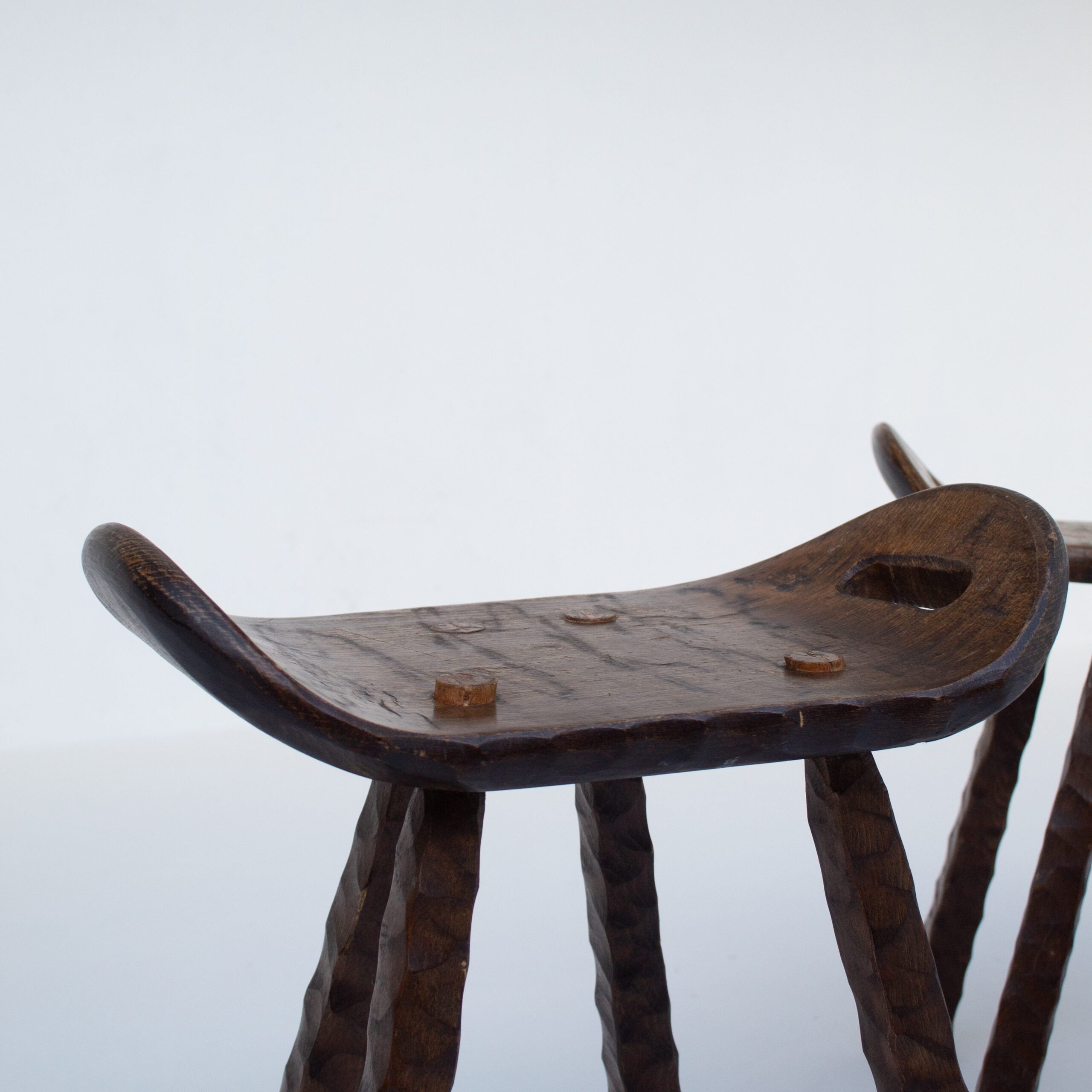 Set of Brutalist stools — back view highlighting dark wood texture