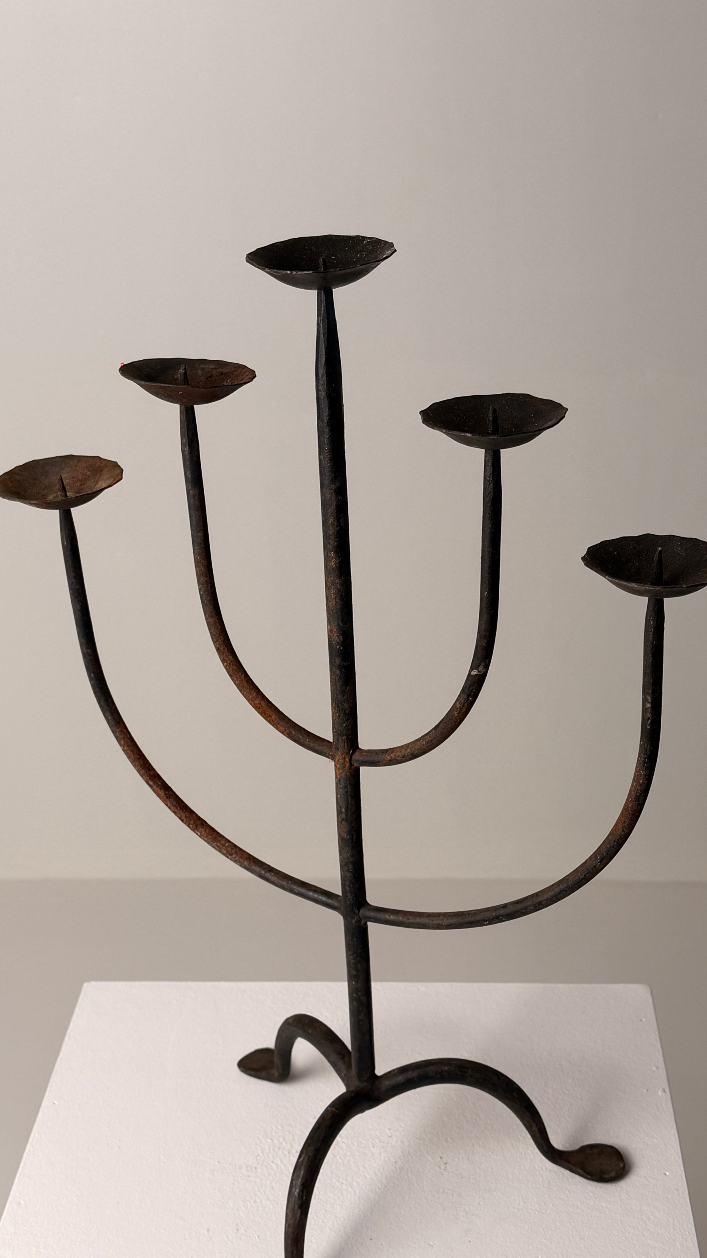Wrought Iron Candelabrum, France, early 20th century — angled view on white pedestal
