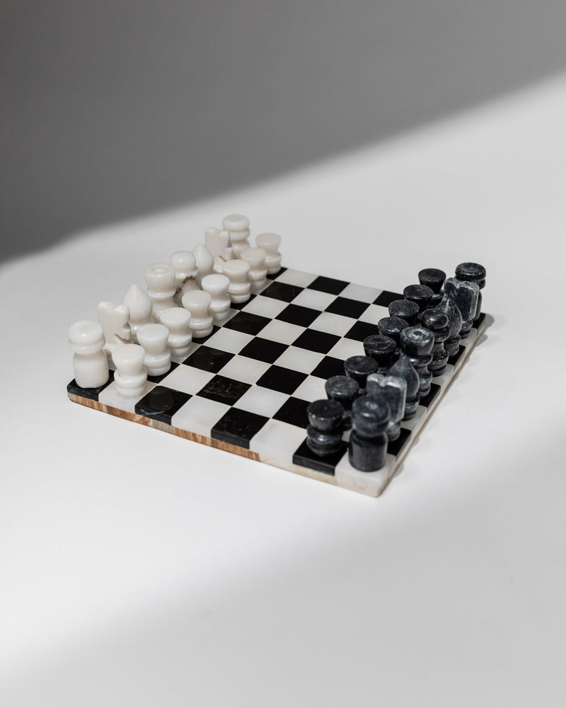 Italian marble chess set with white and black pieces on checkered board
