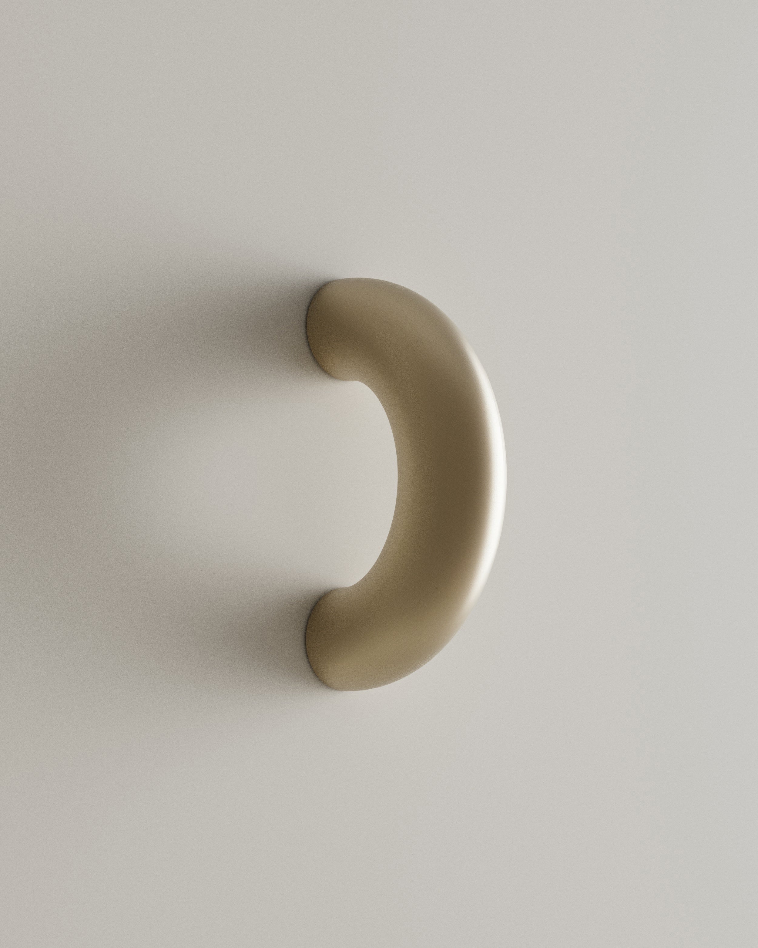 CERCLE Cabinet Pull Thick — side angle of brass handle on light surface