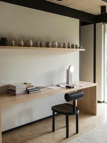 UNA Chair by Estudio Persona — close-up of black wooden seat in modern workspace