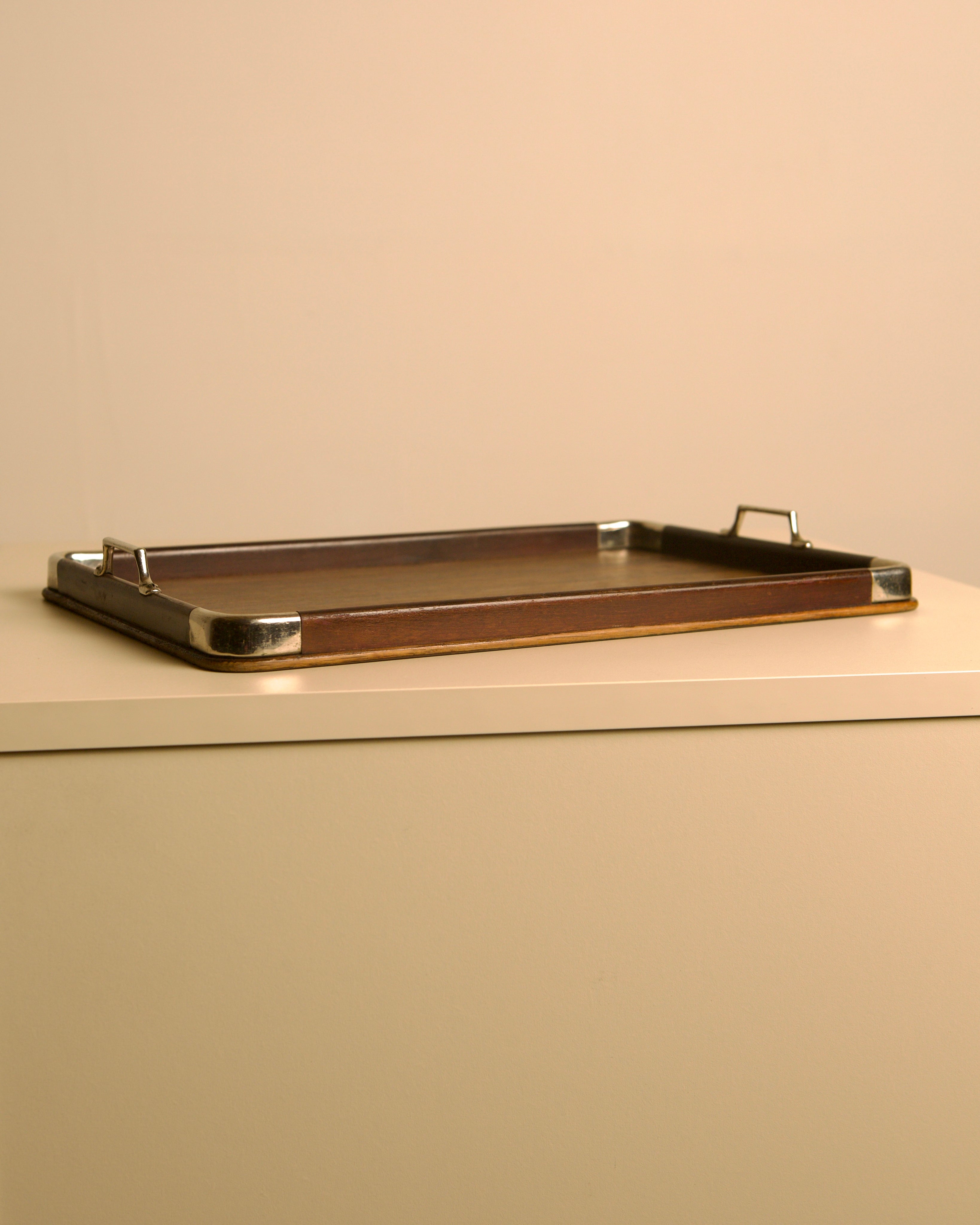 Large Italian tray in wood and metal, 1950s — side angle on neutral surface