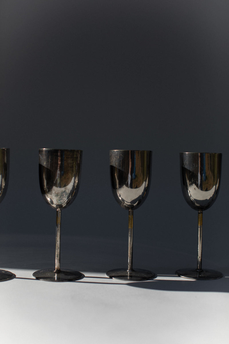 Three elegant brass champagne flutes in dramatic lighting setup