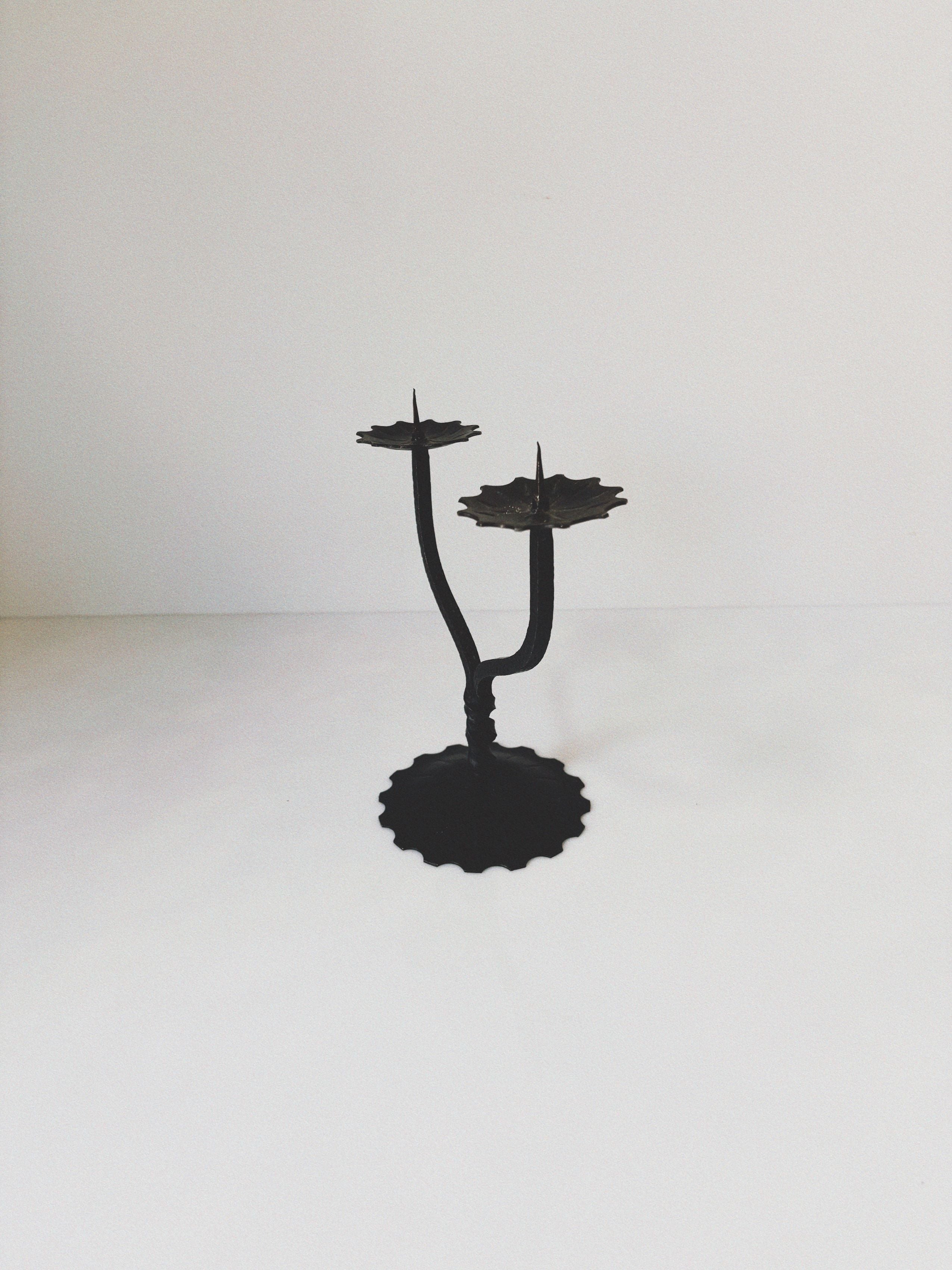 Black metal candleholder with twisted stem and dual candle cups
