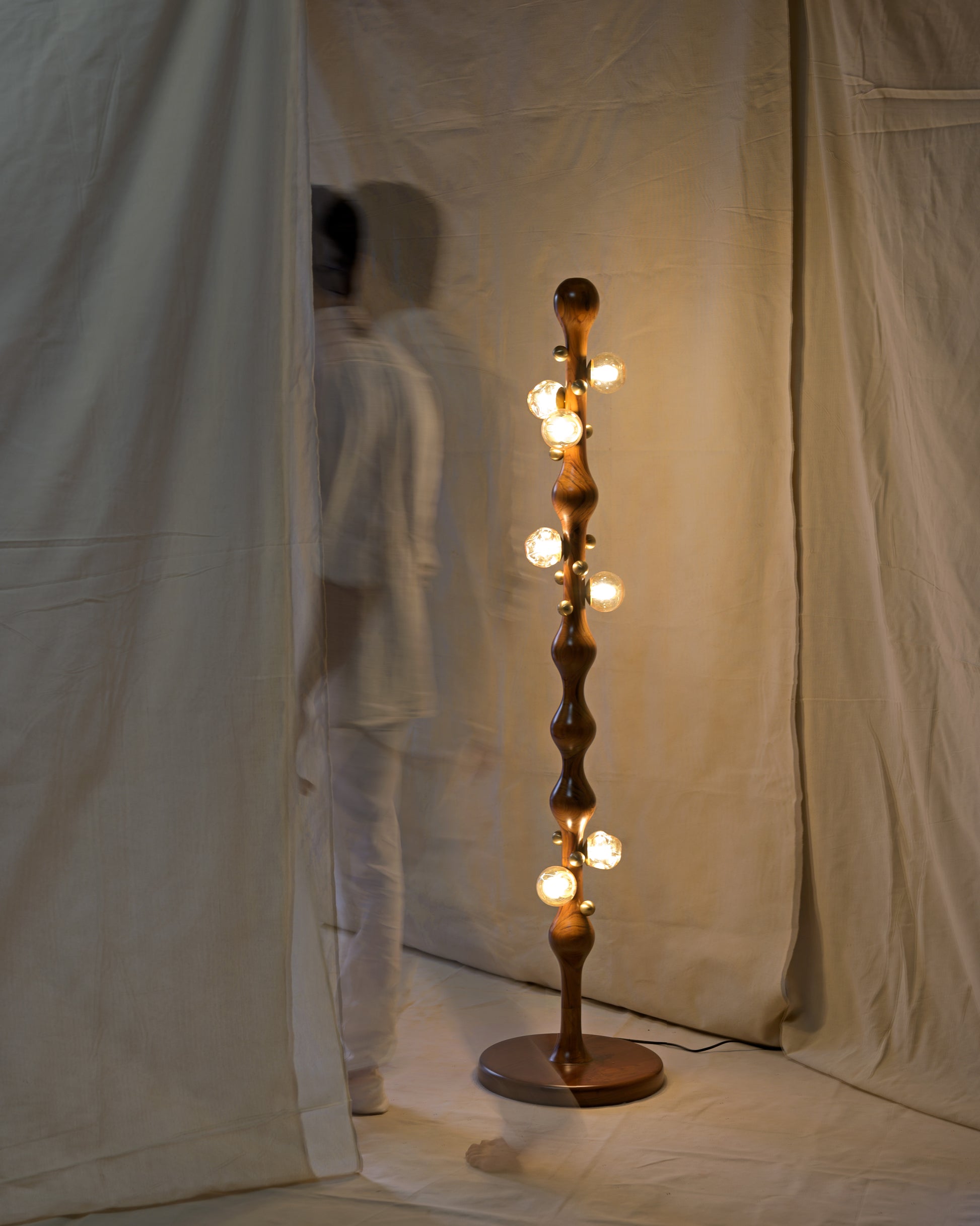 Stem Floor Lamp — side angle with wooden body and glowing bulbs