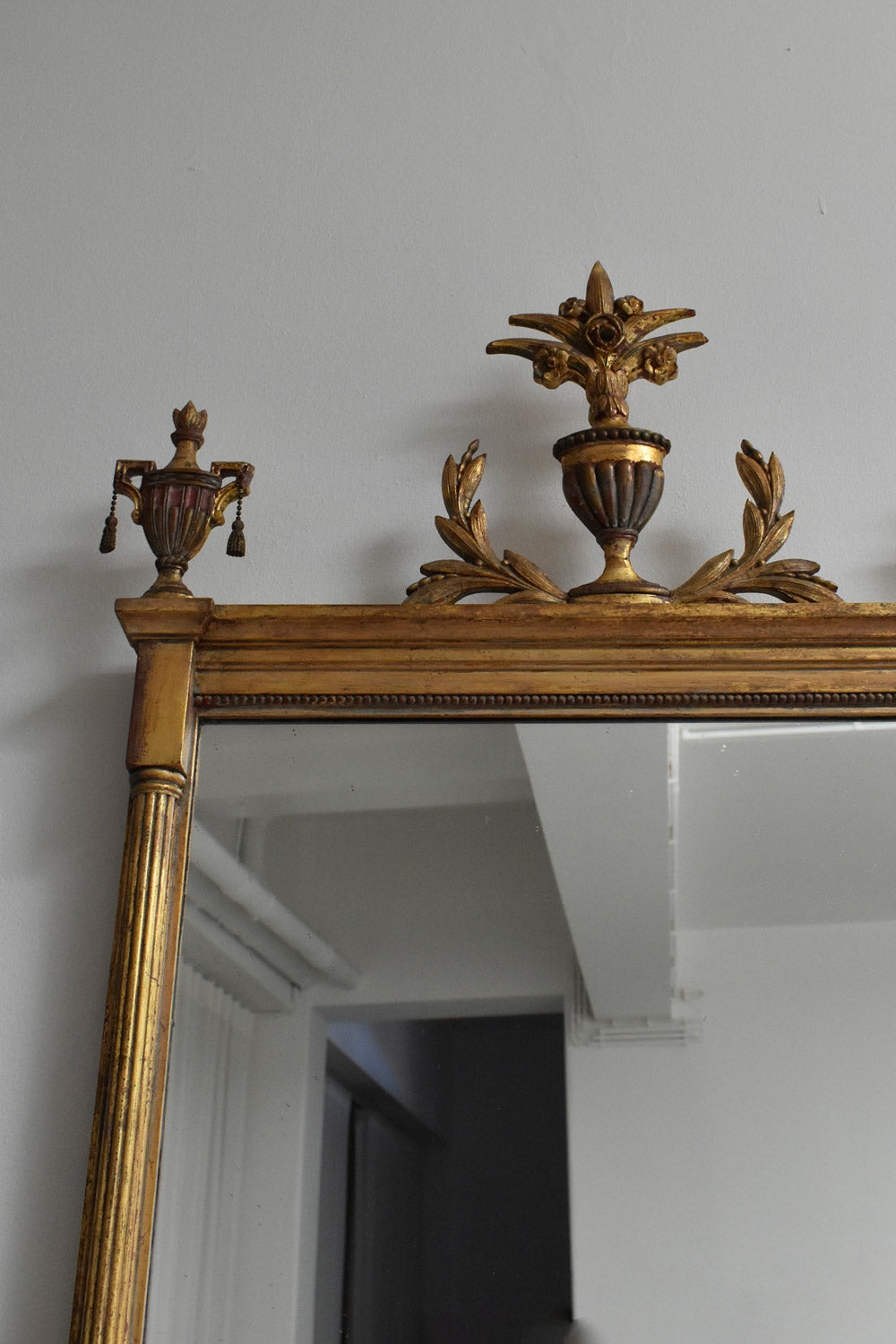 Directoire Style Gilded Wooden Mirror, 1910s — angled view highlighting ornate top detail