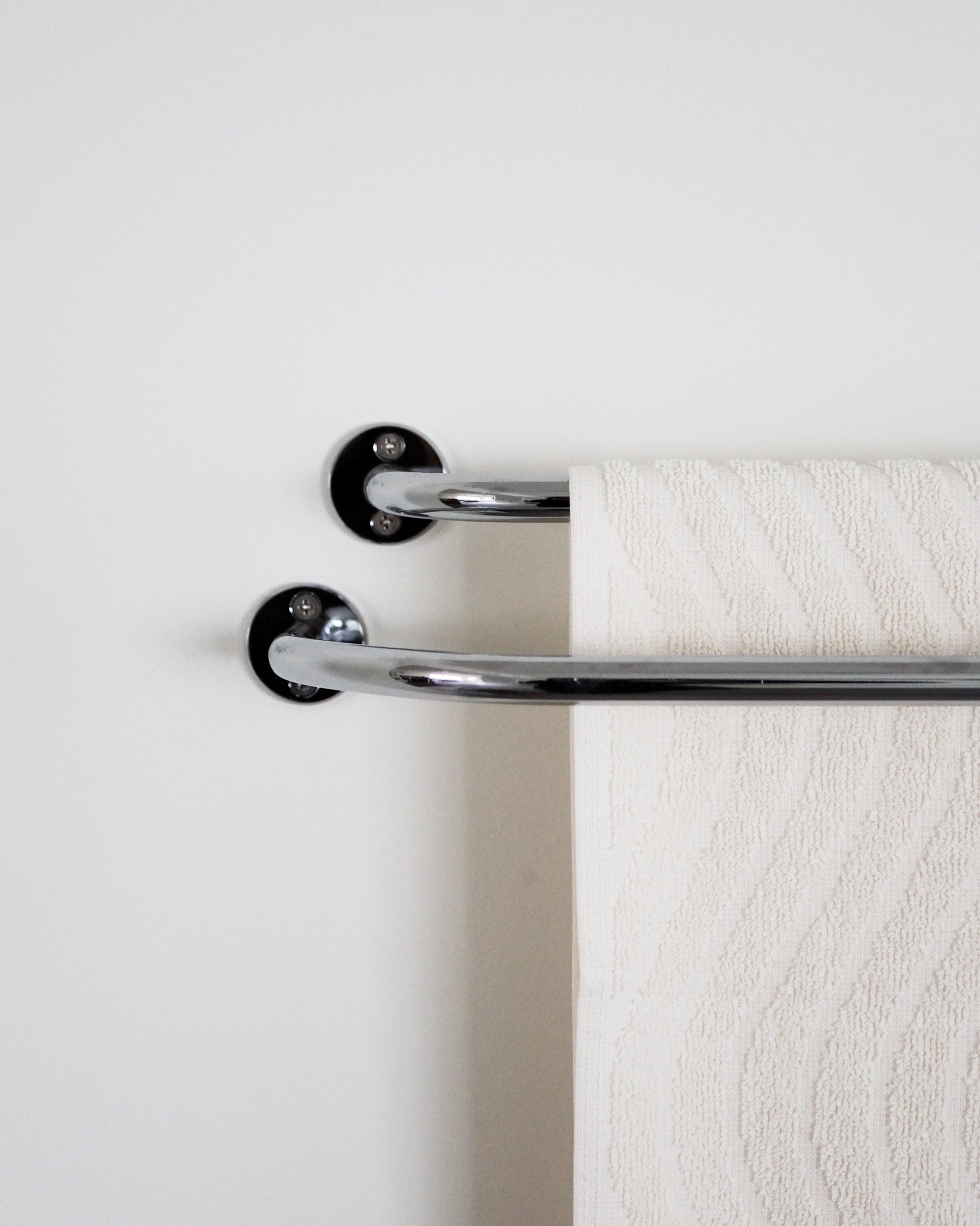 FAUNA Towel Bar Double — close-up of chrome finish with white towel