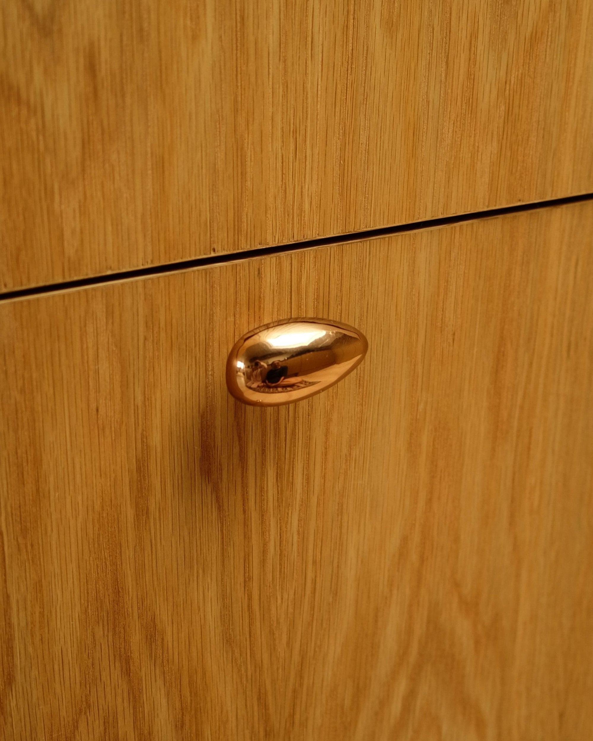 MOMI Cabinet Knob/Wall Hook Long Mini — top view of polished copper knob on wood cabinet