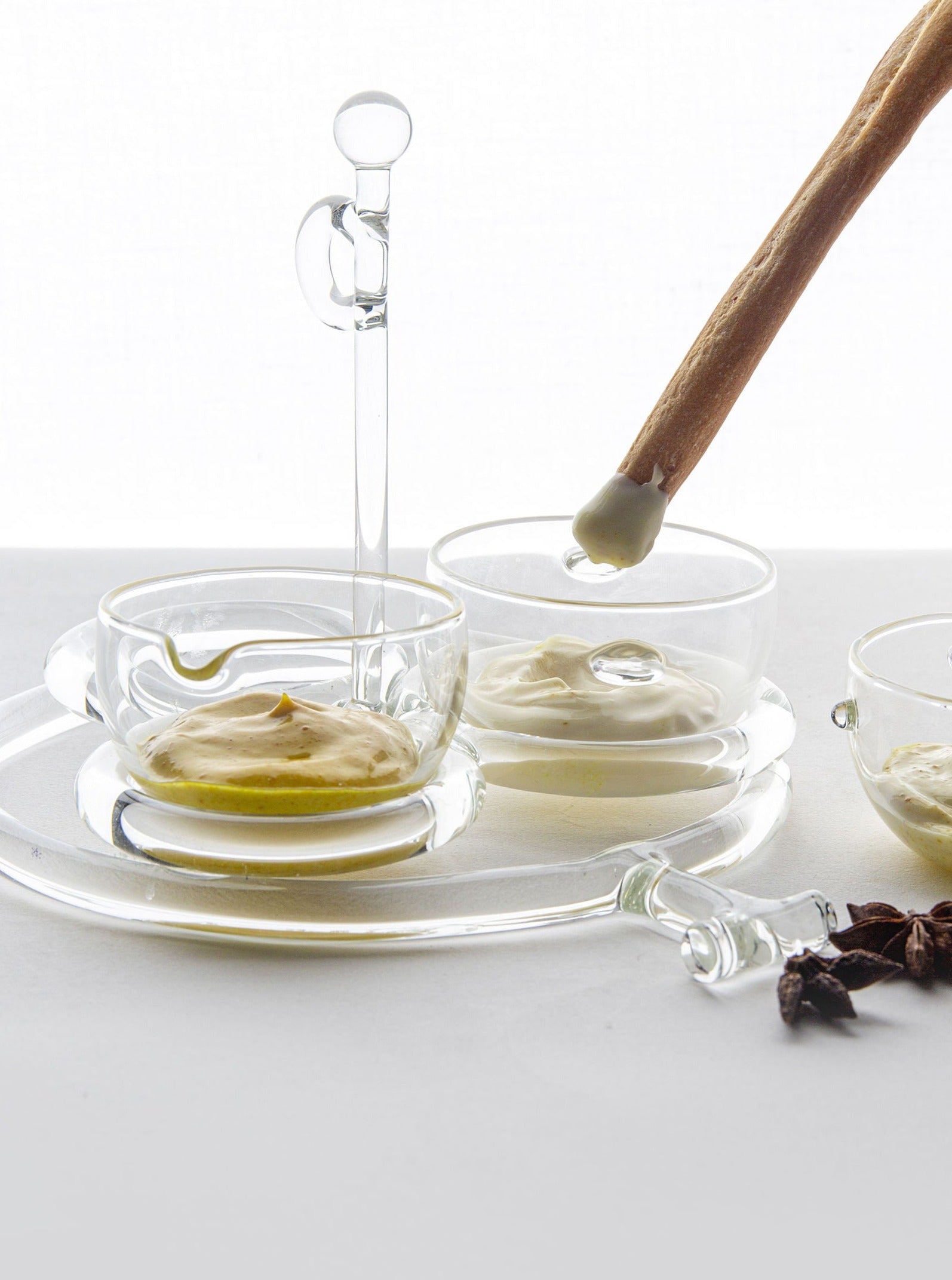 Gravy boat Sio2 — side angle with clear glass and sauces