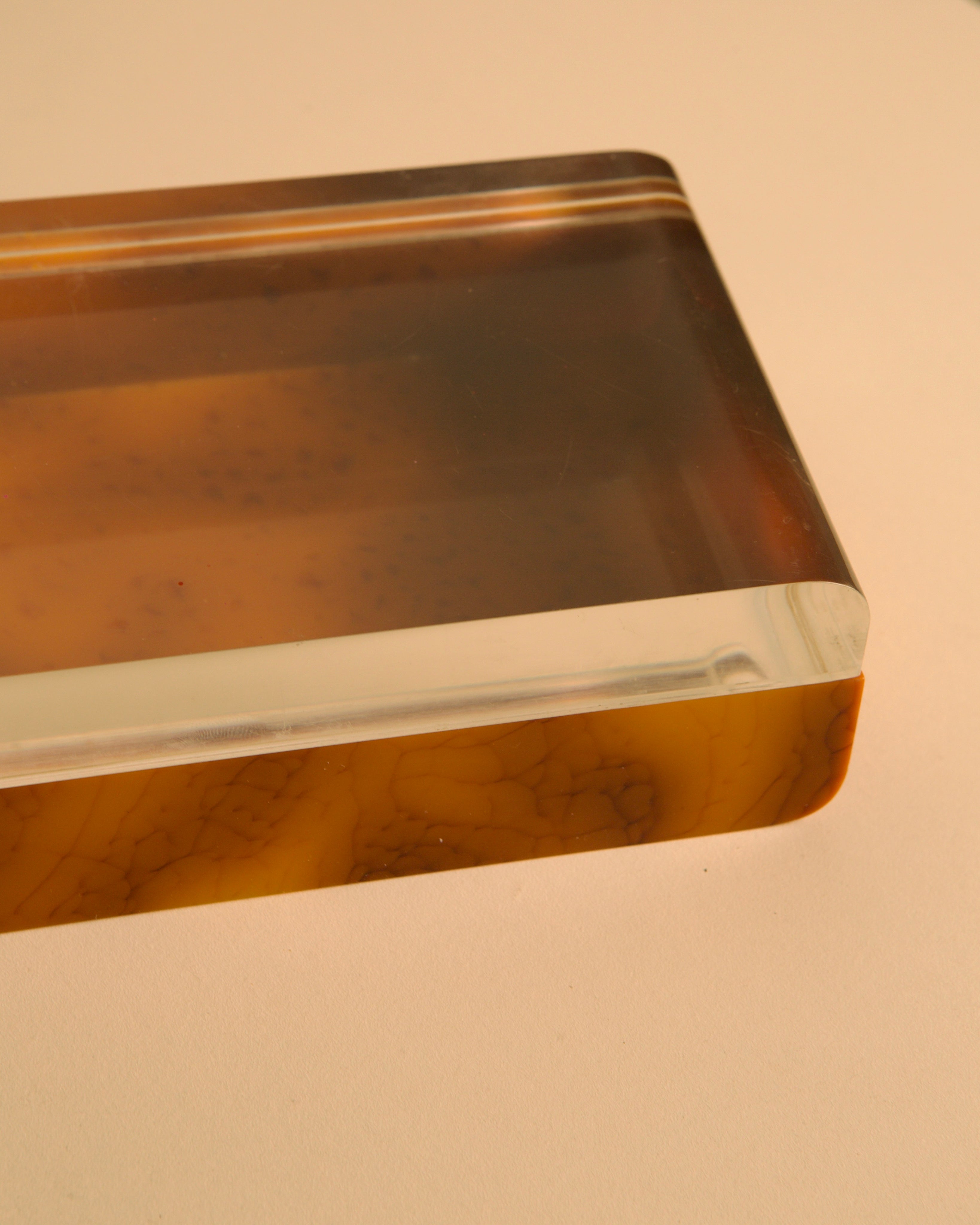 Italian box in plexiglass and brown bakelite, 70s — top view highlighting smooth edges