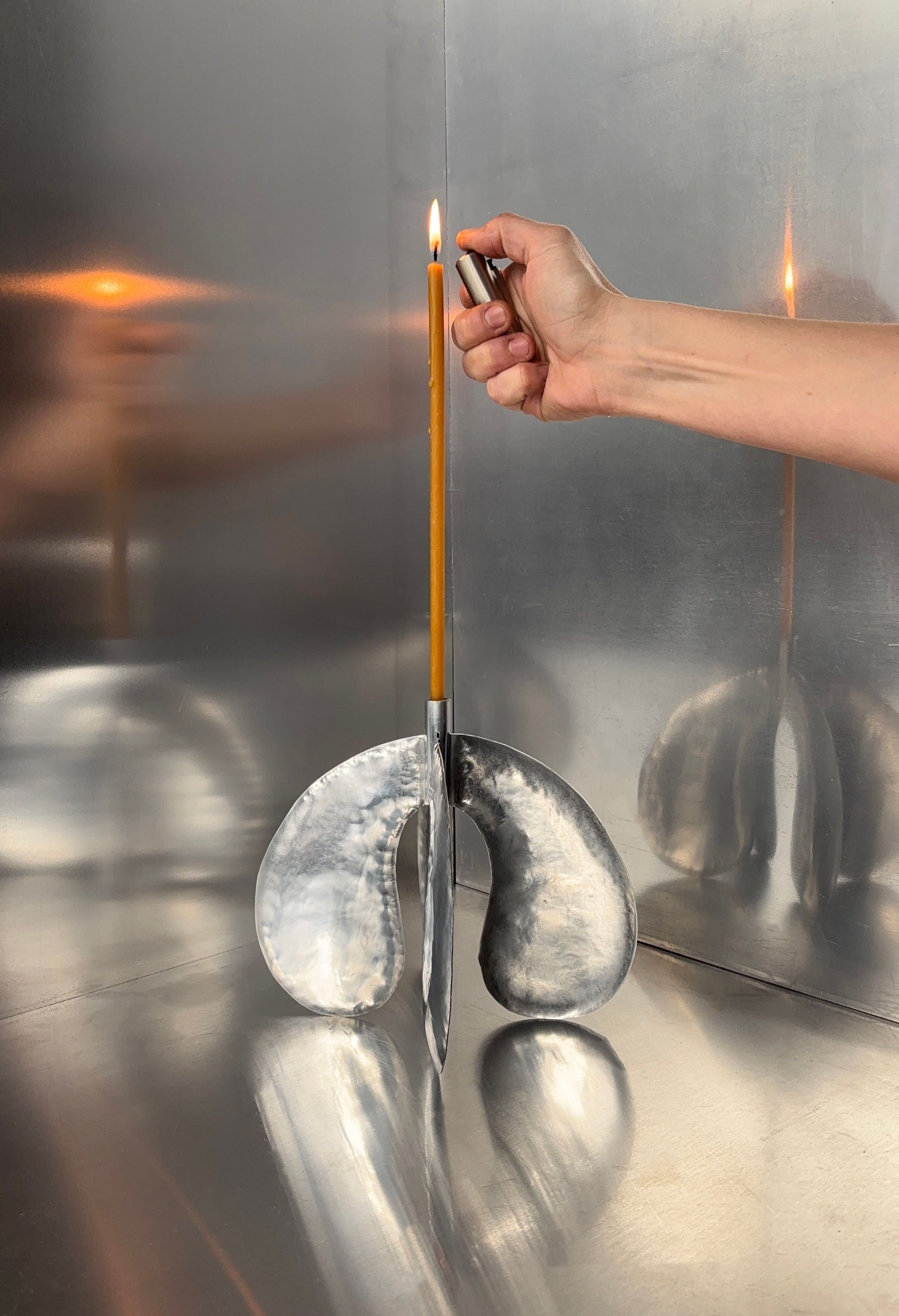 Phaedra Candle Holder Small — top view with hand lighting candle