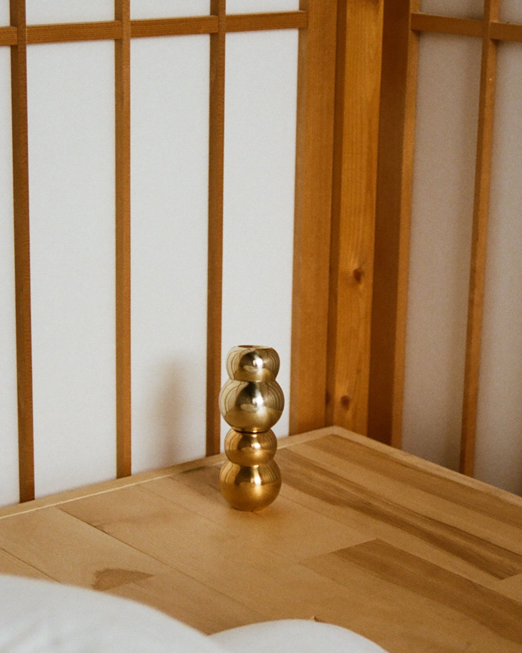 ANJOU Candleholder — back view on wooden table against shoji screen