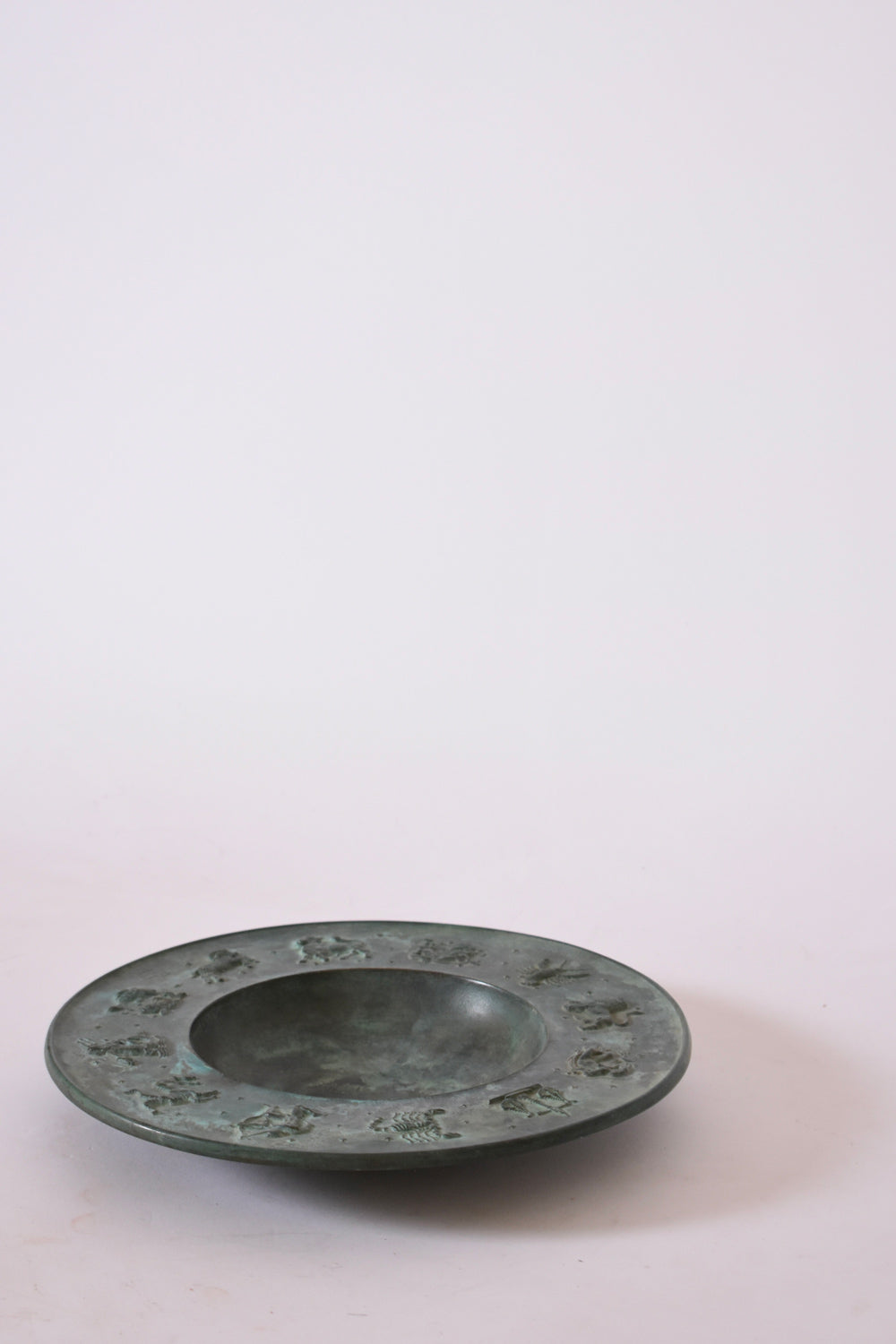 Circular Neoclassical Bronze Plate, 1940s — side angle