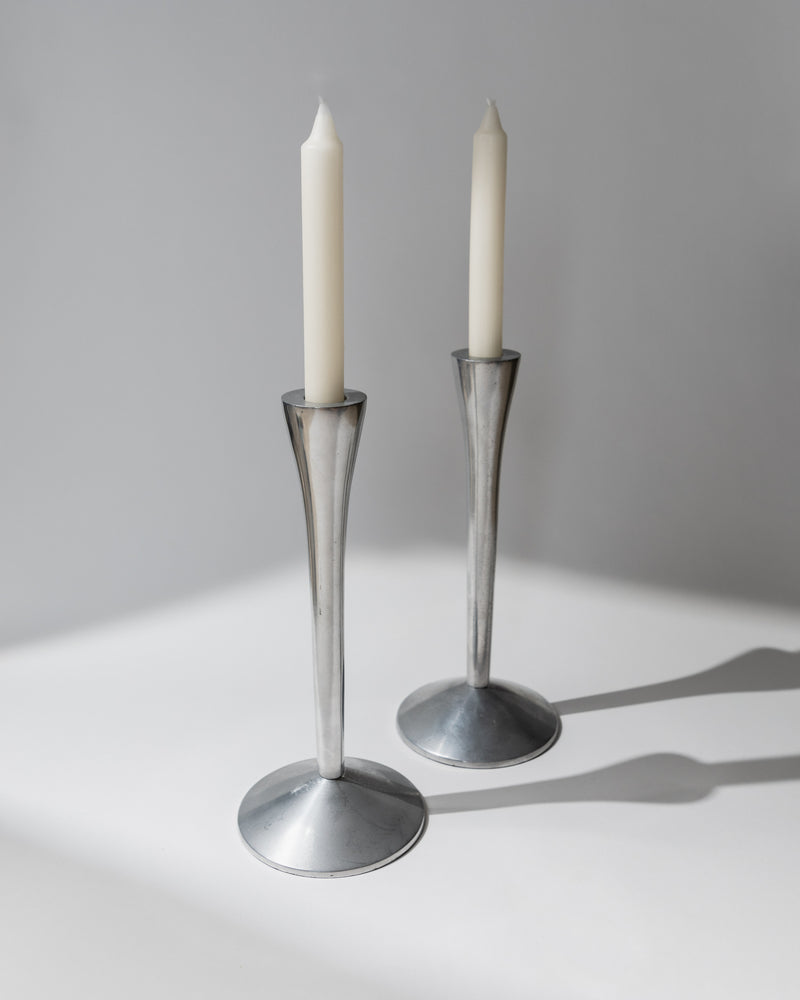 Pair of tall stainless steel candle holders with tapered design