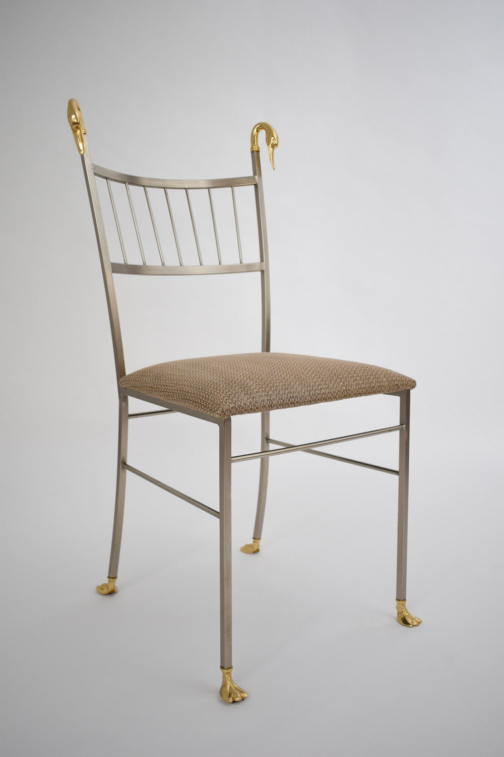 Pair of Swan Chairs — side angle showing metal frame and fabric seat