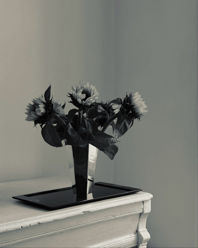 Silver vase with sunflowers on black tray by Tage Göthlin