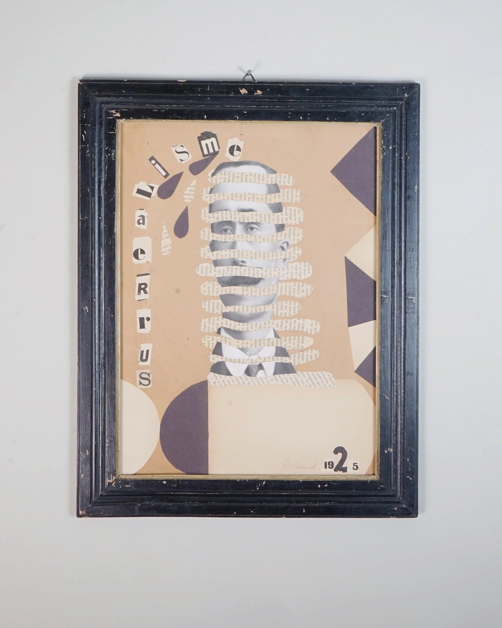 Dadaist Collage - Portrait — close-up of framed paper artwork