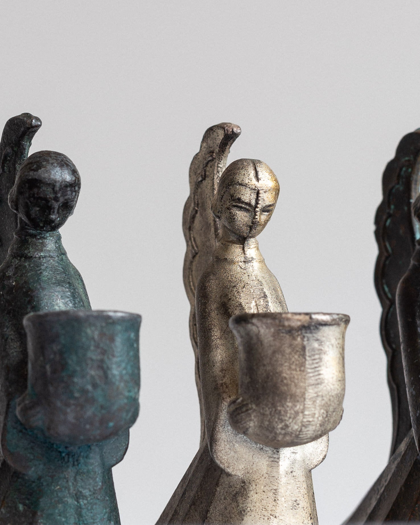 Set of Swedish Art Deco Figural Angel Candlesticks — top view showing metallic finishes and details