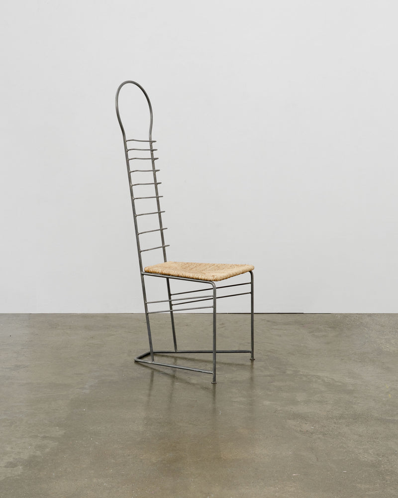 Vintage sculptural steel chair with woven straw seat and tall ladder back