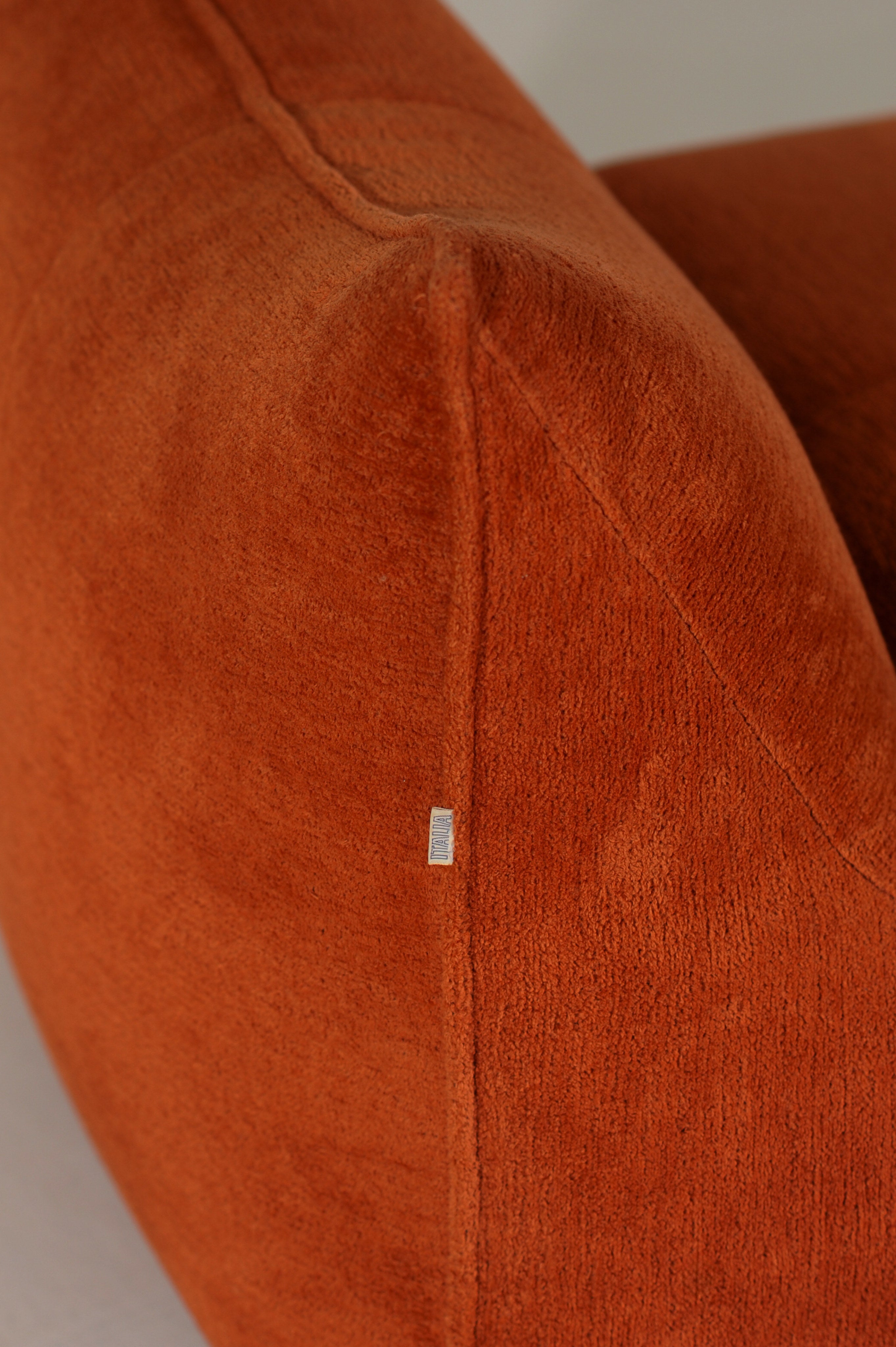 Orange leather Le Bambole armchair detail showing seam construction