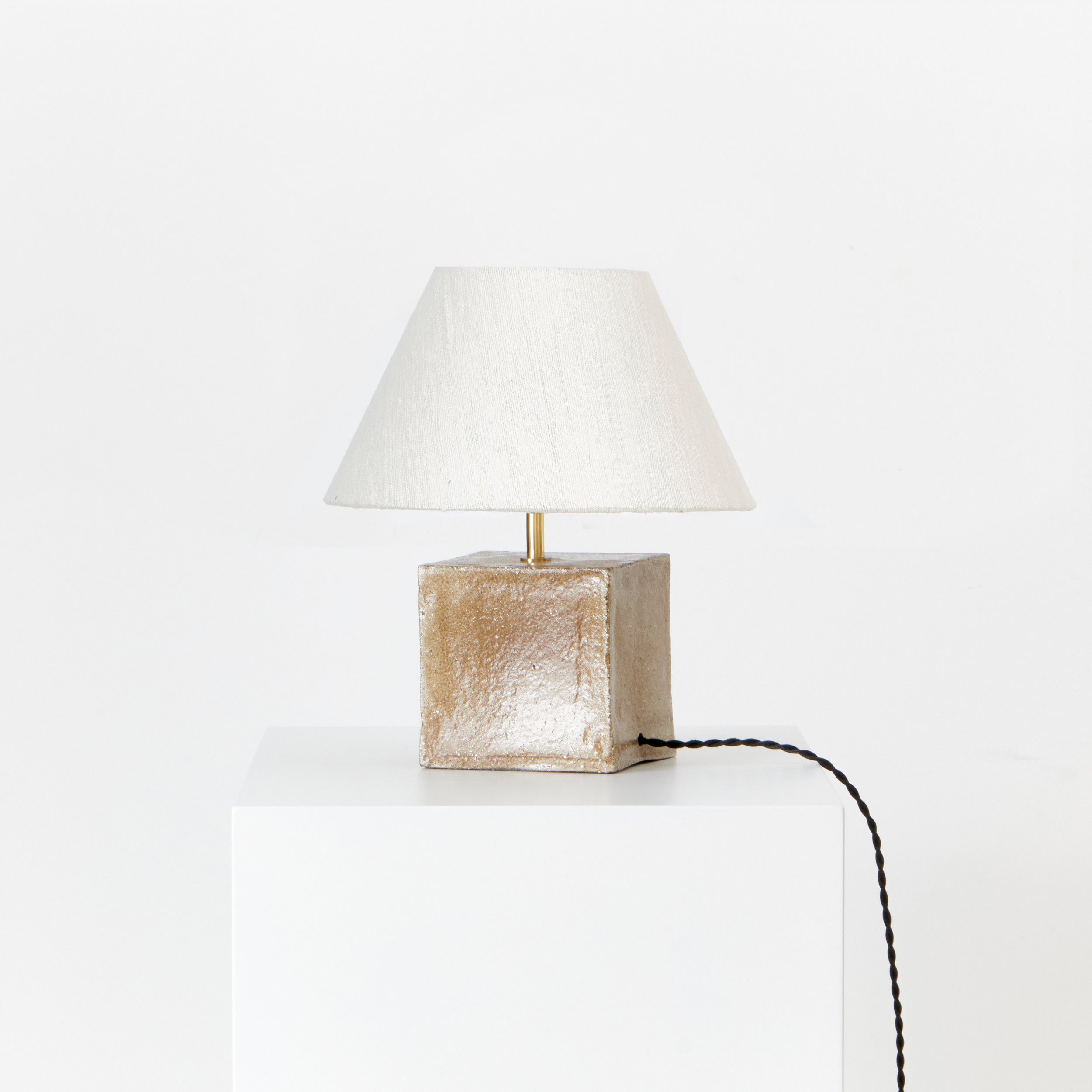 Arouca Table Light Red — angled view on white pedestal