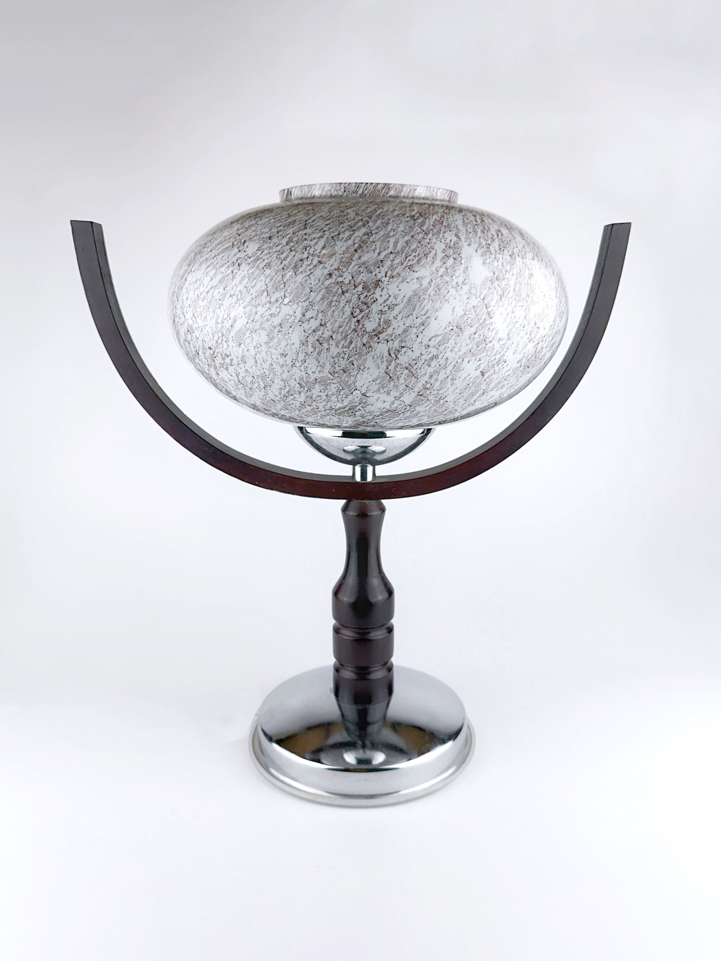 The 1960s Sputnik Age Table Lamp by Dodo Vintage features a round, textured white shade, dark curved arms, and a black and silver base, offering clean, minimalist style against a plain white background.