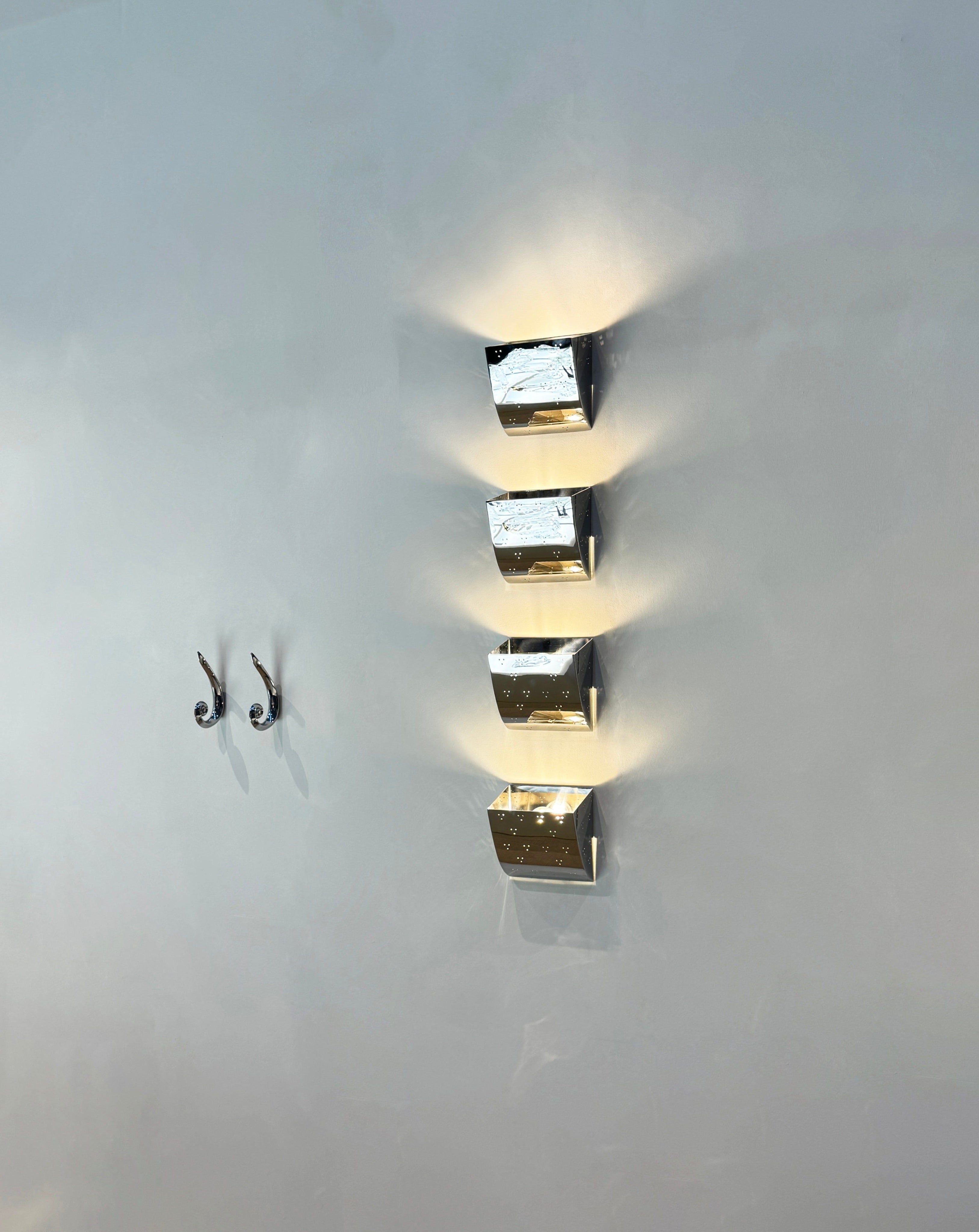 Jolene Wall Lamp - Polished Steel — close-up of polished steel texture on wall